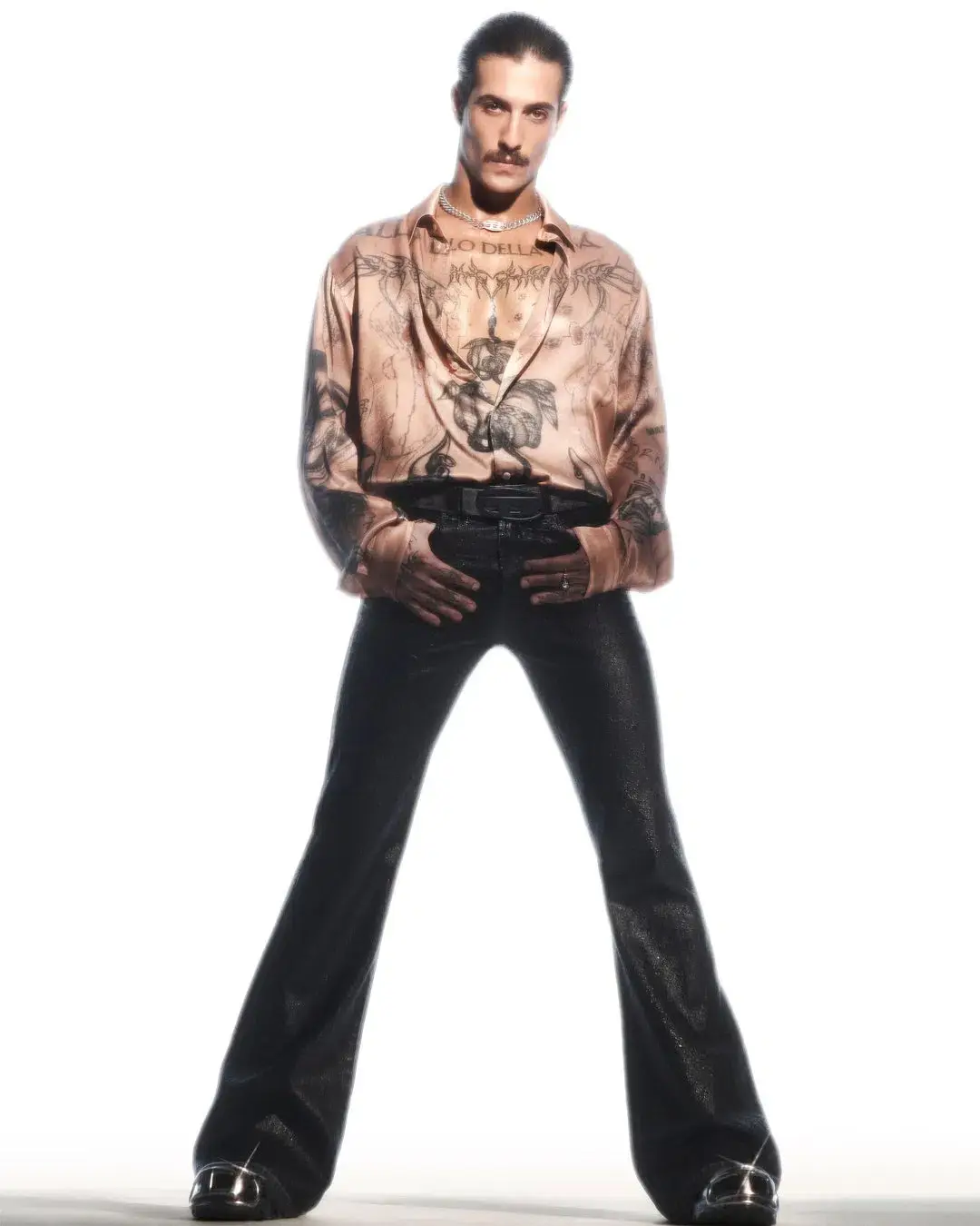 Diesel The article discusses a new capsule collection collaboration between the fashion brand Diesel and Damiano David, the lead singer of the band Måneskin. The collection combines Diesel's edgy, gender-fluid aesthetic with elements inspired by Damiano's personal style and tattoos. Key pieces include oversized tops, drawstring pants, and denim items with distinctive treatments. The capsule is now available for purchase on Diesel's website. (image 10 of 10)
