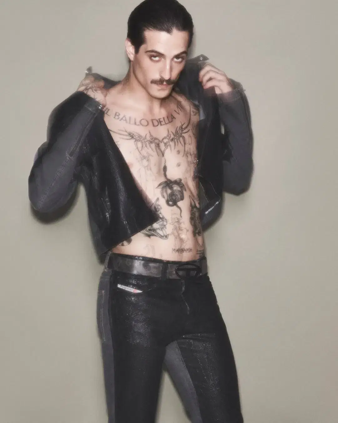 Diesel The article discusses a new capsule collection collaboration between the fashion brand Diesel and Damiano David, the lead singer of the band Måneskin. The collection combines Diesel's edgy, gender-fluid aesthetic with elements inspired by Damiano's personal style and tattoos. Key pieces include oversized tops, drawstring pants, and denim items with distinctive treatments. The capsule is now available for purchase on Diesel's website. (image 6 of 10)