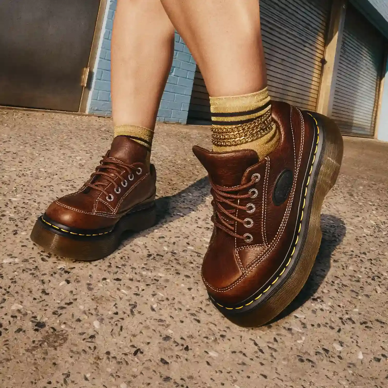 Dr. Martens Elphie ballet flat featuring pointed toe design with wrap-around laces, shown in black leather with street-style details.