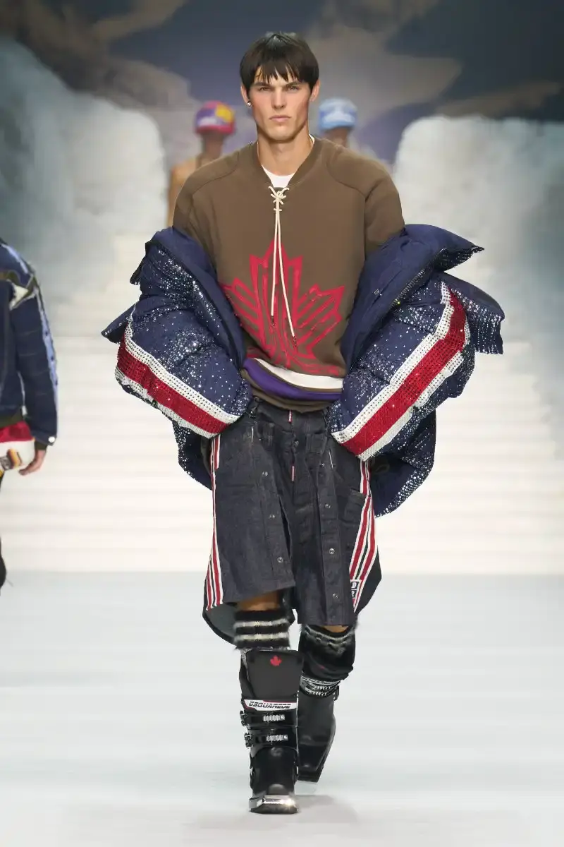 DSQUARED2 FALL/WINTER 2026 MENSWEAR DSQUARED2 Fall/Winter 2026 menswear collection at Milan Fashion Week features ski slope aesthetics, oversized puffers, technical sportswear, and Canadian-inspired designs with emphasis on layering and attitude. (image 13 of 14)