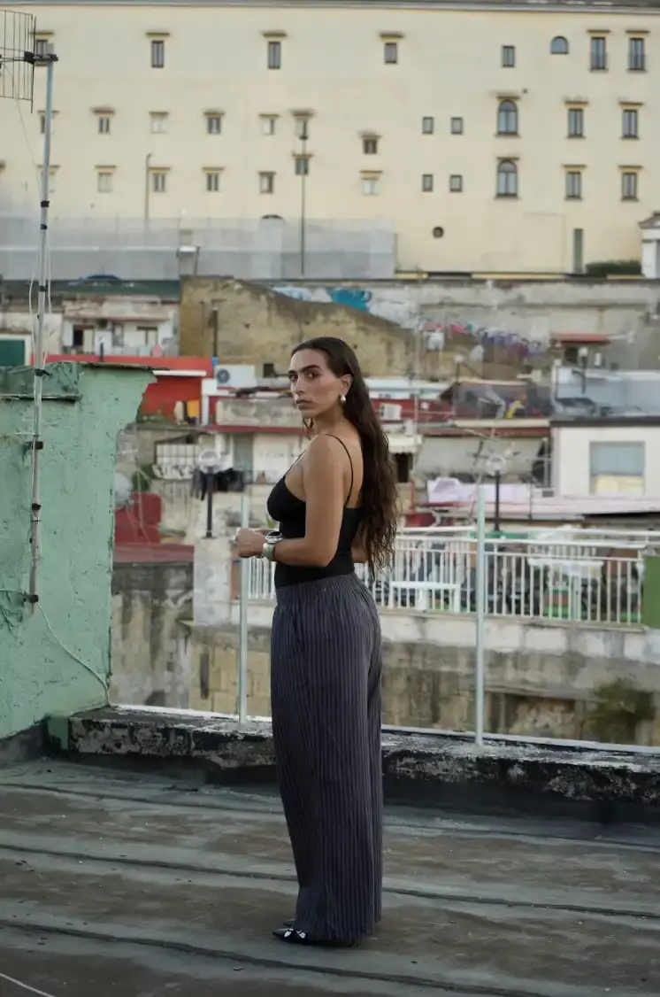 THROUGH THE EYES OF ELLYNORA: WHERE VOICE MEETS VIBE image of Ellynora, an Italian-American electronic artist who combines singing and DJing. The piece covers her multicultural background, creative process, performance style, and upcoming projects including her 99xcent brand that merges music with fitness events. (image 2 of 5)