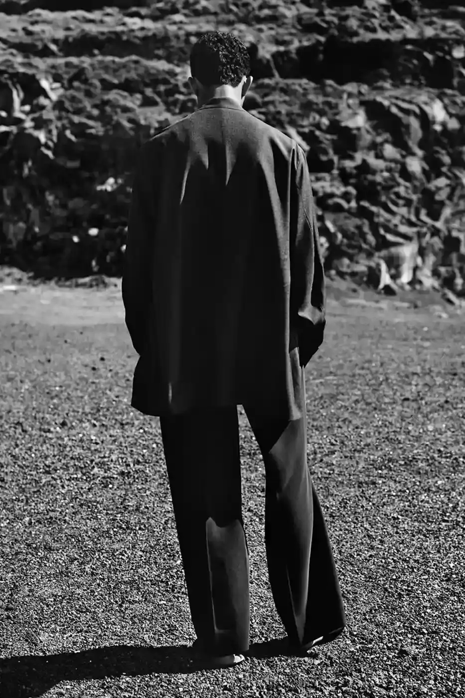 EMPORIO ARMANI AND OUR LEGACY: A SECOND CHAPTER IN DESIGN DIALOGUE image of second collaboration between Emporio Armani and Our Legacy Work Shop, detailing the expanded capsule collection that includes both menswear and womenswear. The collection features designs reimagined from Armani archives with East Asian influences, using both classic and recreated vintage fabrics. The article describes the campaign photographed by Alasdair McLellan on Pantelleria island, and provides information about the May 16 launch date and various retail locations where the collection will be available. (image 4 of 7)