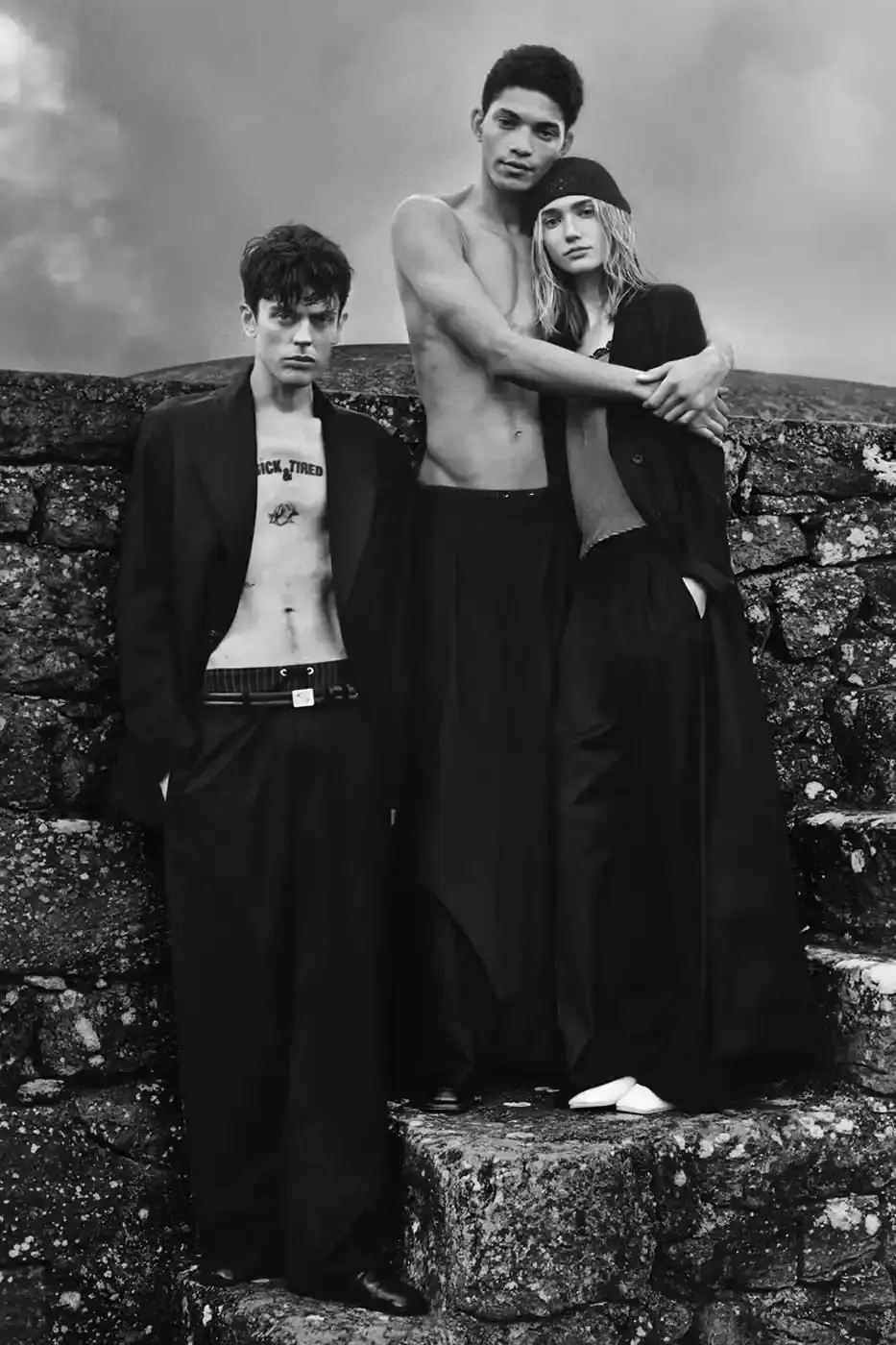 EMPORIO ARMANI AND OUR LEGACY: A SECOND CHAPTER IN DESIGN DIALOGUE image of second collaboration between Emporio Armani and Our Legacy Work Shop, detailing the expanded capsule collection that includes both menswear and womenswear. The collection features designs reimagined from Armani archives with East Asian influences, using both classic and recreated vintage fabrics. The article describes the campaign photographed by Alasdair McLellan on Pantelleria island, and provides information about the May 16 launch date and various retail locations where the collection will be available.