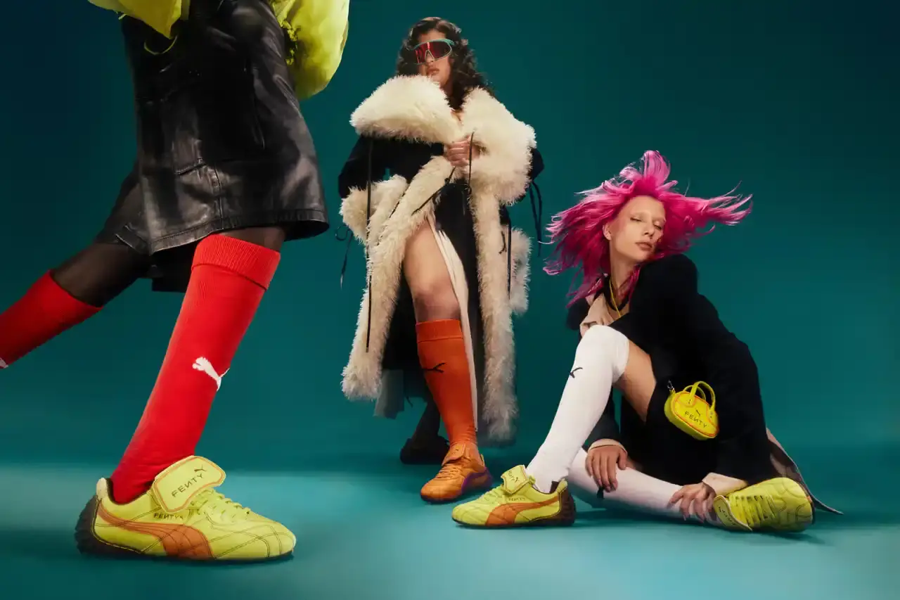 Puma FENTY x PUMA launches neon-colored Avanti LS sneakers, Cat Cleat Jelly slides, and Pocket Bags. Available worldwide March 13 in yellow and orange.