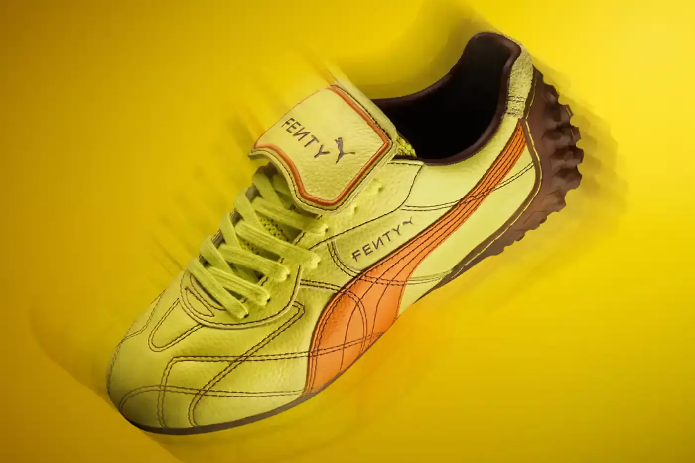 Puma FENTY x PUMA launches neon-colored Avanti LS sneakers, Cat Cleat Jelly slides, and Pocket Bags. Available worldwide March 13 in yellow and orange. (image 6 of 9)