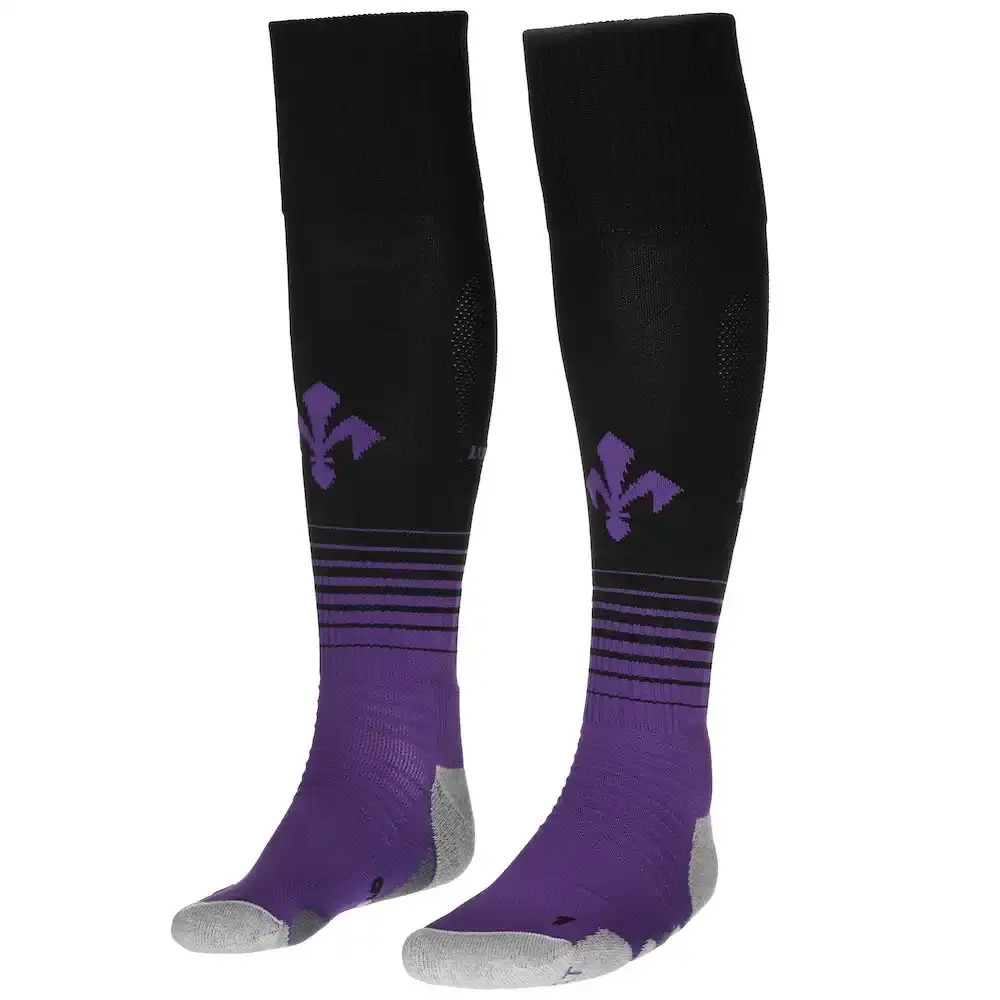 Kappa Fiorentina's 2024-25 fourth kit featuring a gradient purple design on black base with iridescent logos, shown with matching shorts and socks. The jersey displays a polo-style collar and the iconic Fleur-de-lis symbol of Florence. (image 3 of 4)