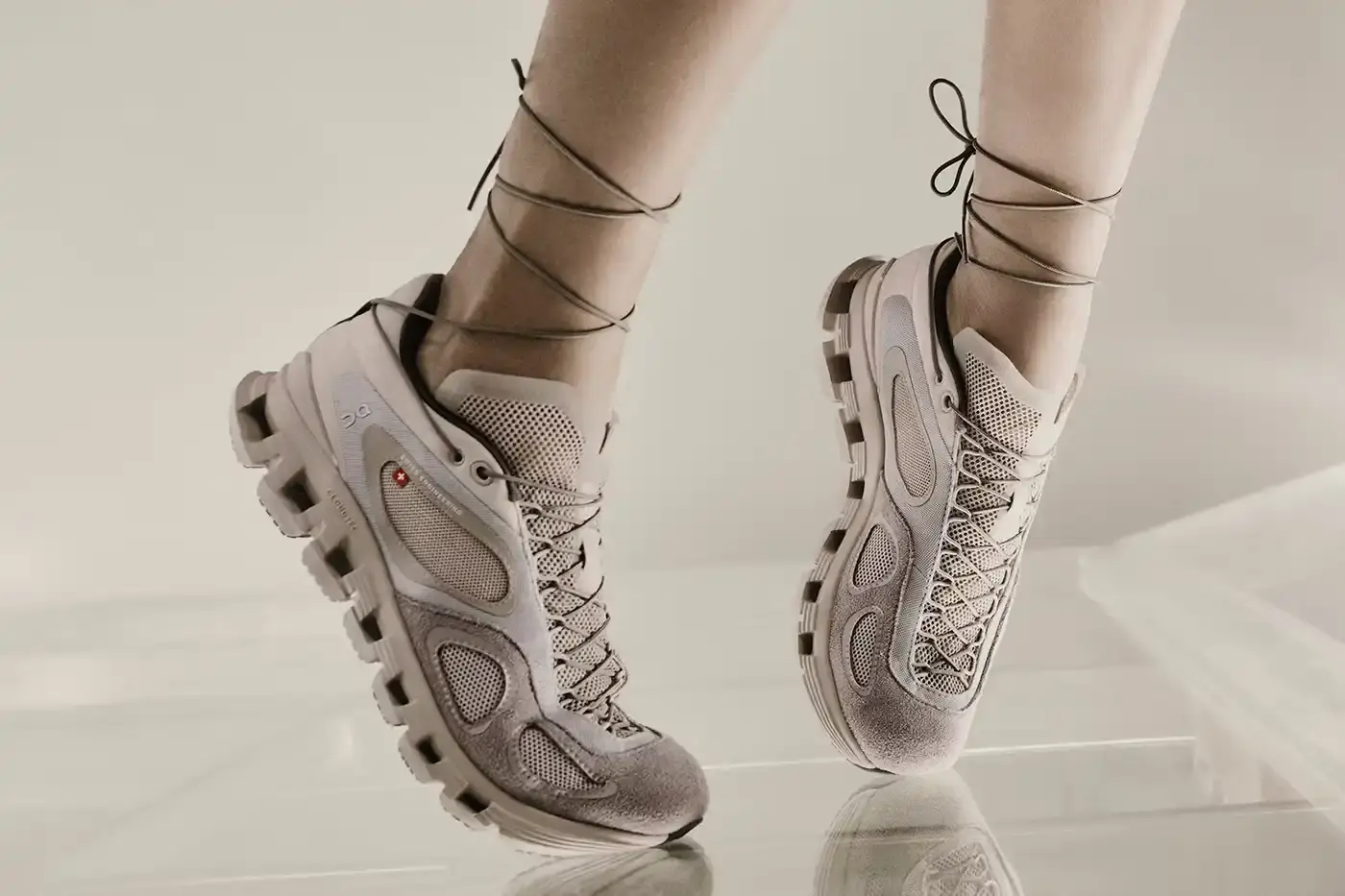 FKA TWIGS AND ON LAUNCH ATHLETIC COLLECTION image announces the launch of a new athletic wear collaboration between musician FKA twigs and sportswear brand On. The collection includes a dance-inspired sneaker called Cloud x FKA and various athletic apparel pieces in neutral colors. The article explains the design philosophy behind the collaboration, focusing on versatility for people with active, varied lifestyles. It includes quotes from FKA twigs about creating clothing that adapts to different daily activities, from training to meetings to studio work. The collection will be available for purchase starting June 26 through On's website. (image 2 of 6)