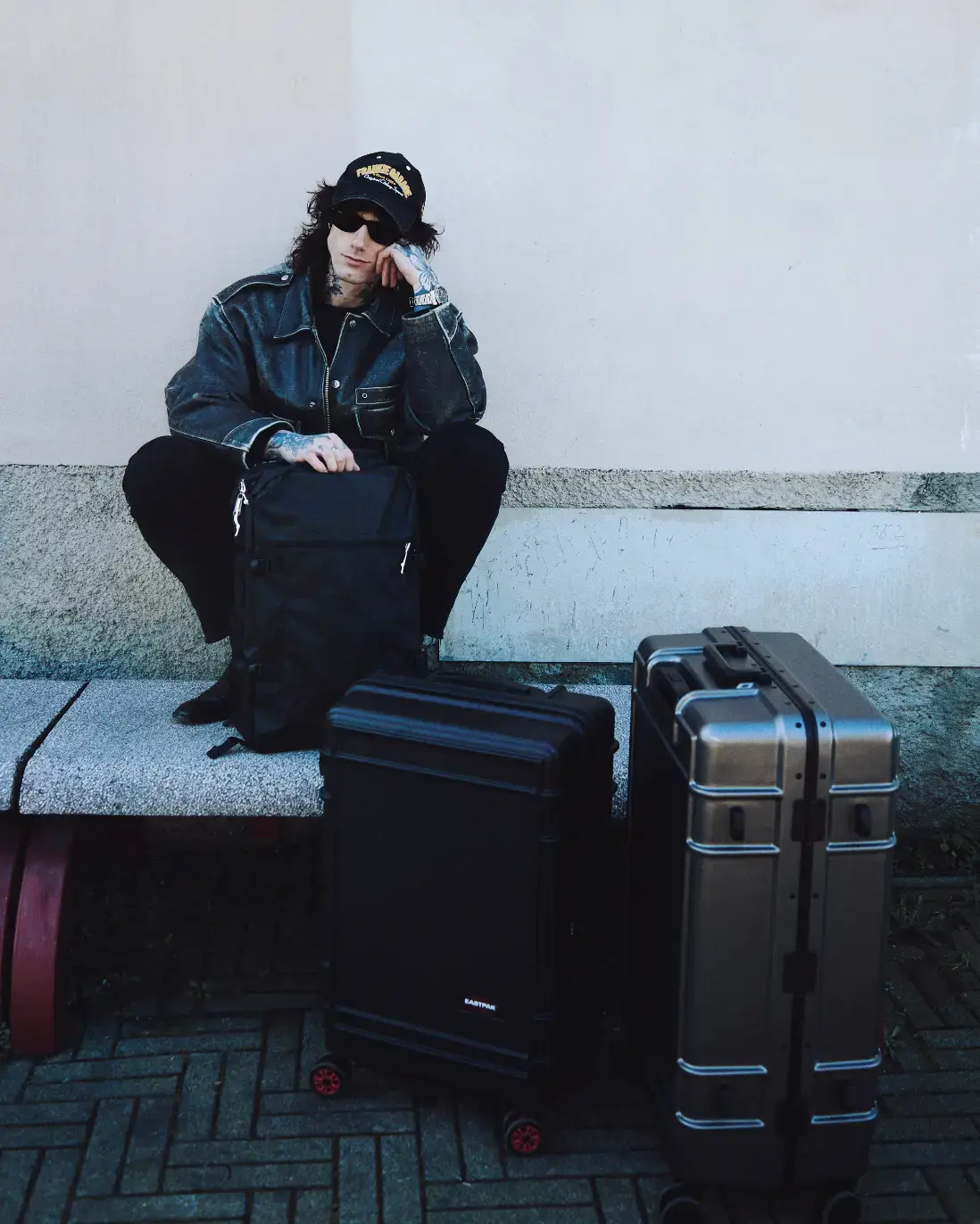 CREATIVITY IN MOTION WITH STYLIST FRANCESCO MAUTONE Stylist Francesco Mautone carrying an Eastpak bag while walking through a modern hotel lobby, representing creativity in motion. Photography by Simone Paccini (image 2 of 3)