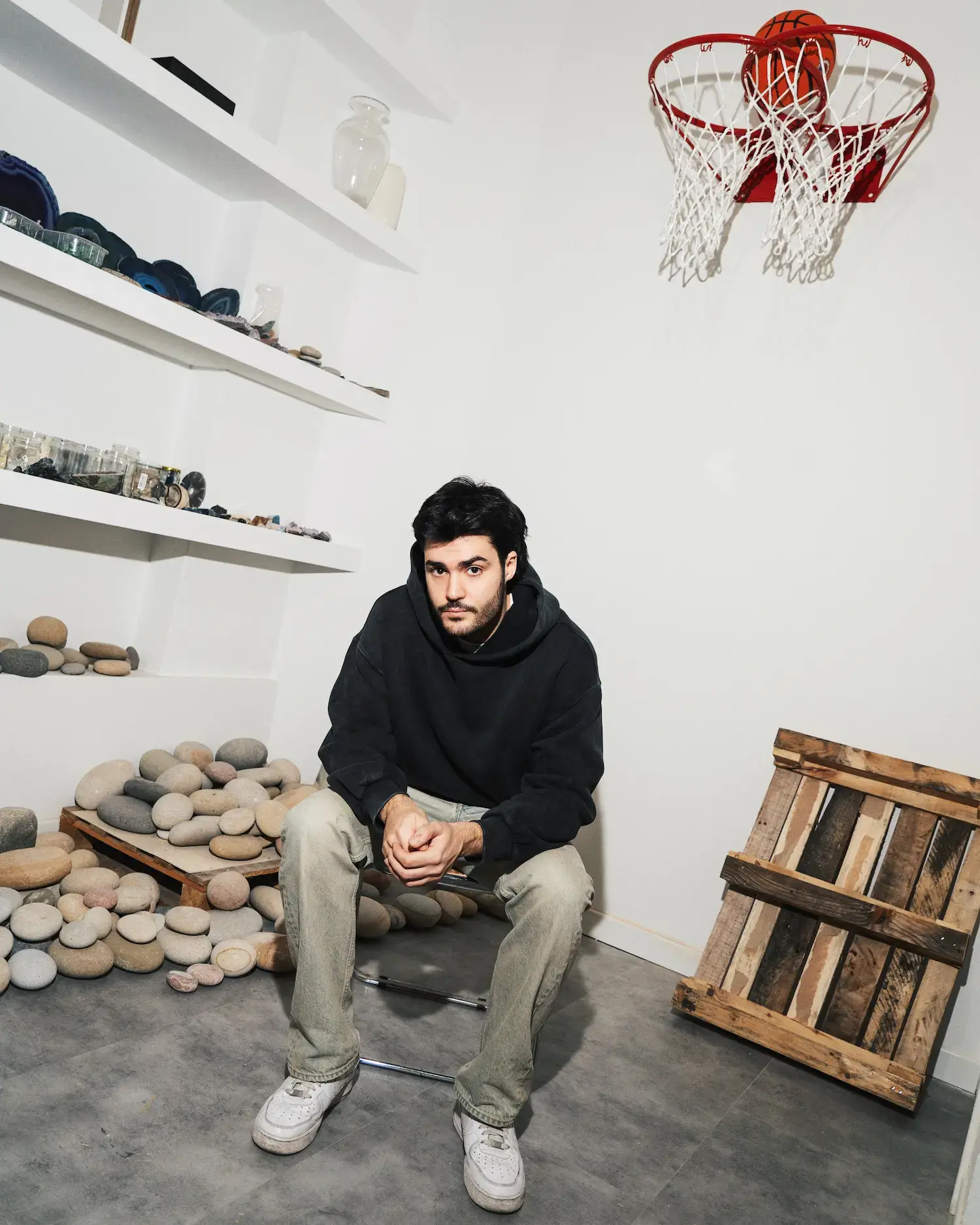 Francesco Vullo in his Milan studio working on a sculptural piece, demonstrating his hands-on creative process with physical materials.