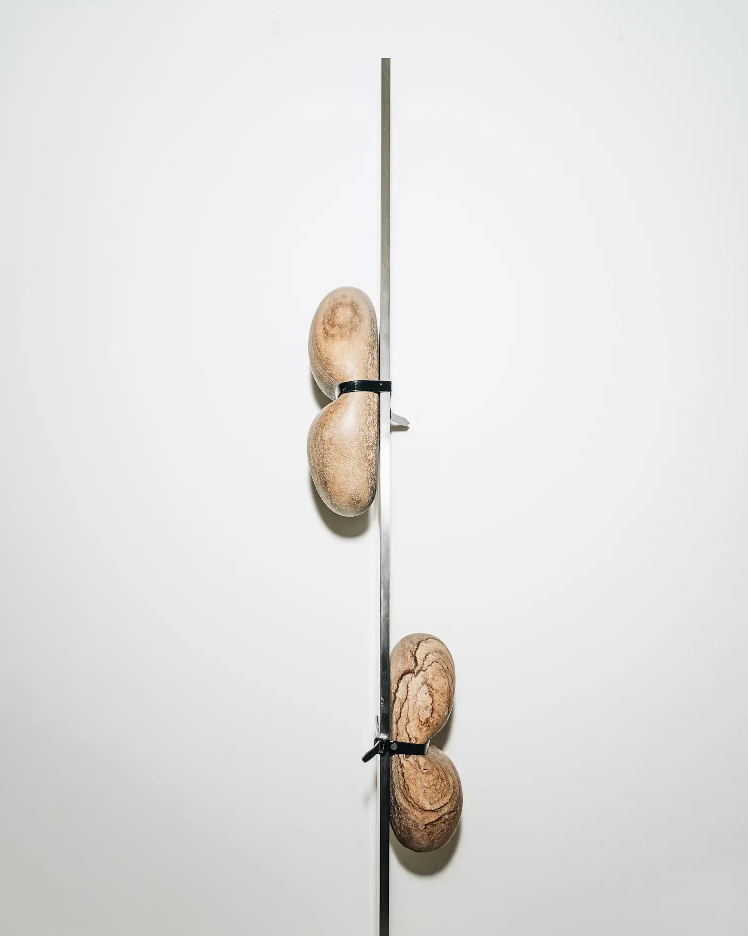 A surrealist stone artwork by Francesco Vullo showing his Magritte-inspired approach to manipulating familiar objects in unexpected ways.