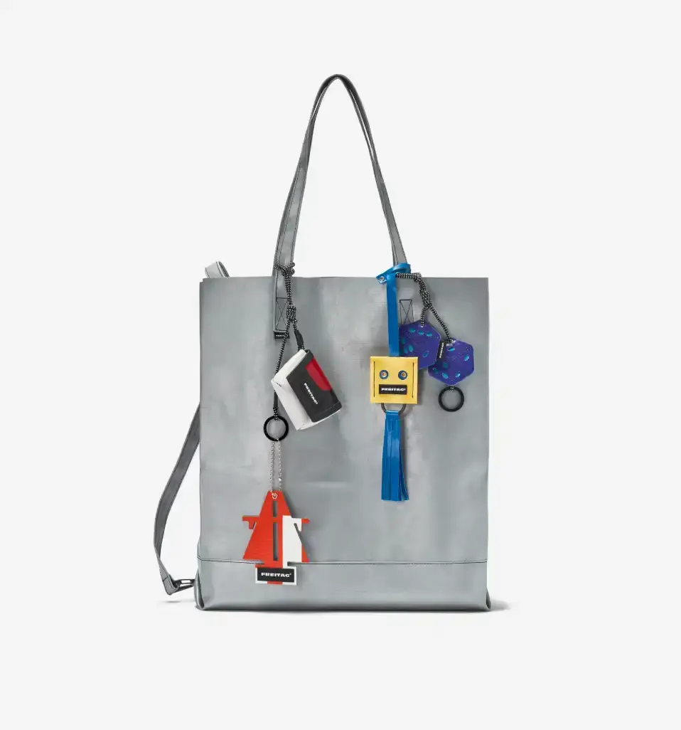 FREITAG TRANSFORMS PRODUCTION WASTE INTO BAG CHARMS image about FREITAG's new Lucky Trucking Charms collection, which repurposes production waste from truck tarps into bag accessories and keychains. (image 4 of 9)