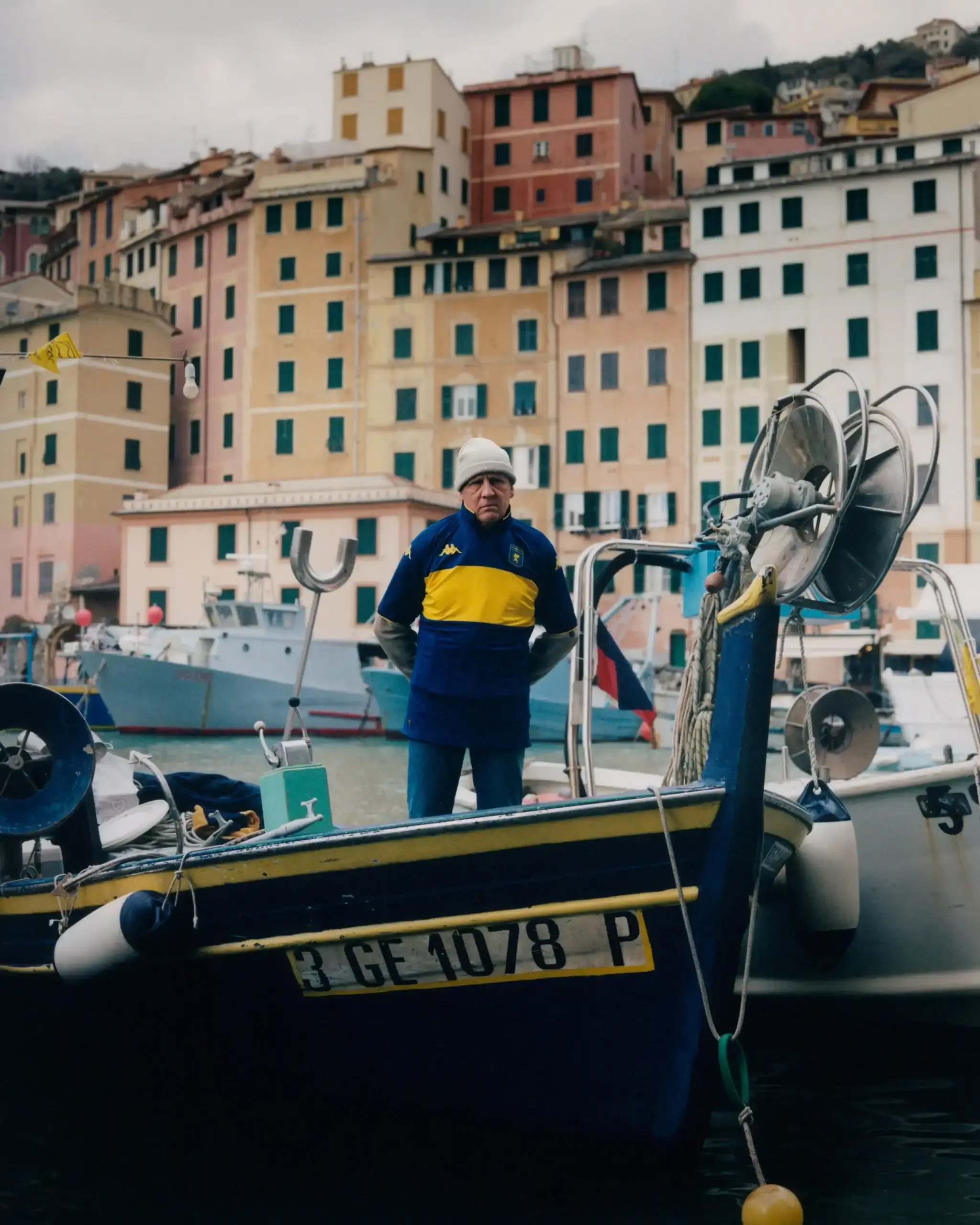 This image depicts Genoa's fourth kit, a dark blue jersey with a horizontal gold stripe, symbolizing the historical connection between Genoa Calcio and Boca Juniors. The jersey features the Genoa Griffon emblem and a special "ZENEIXI" inscription, representing the shared Italian-Argentine football heritage.