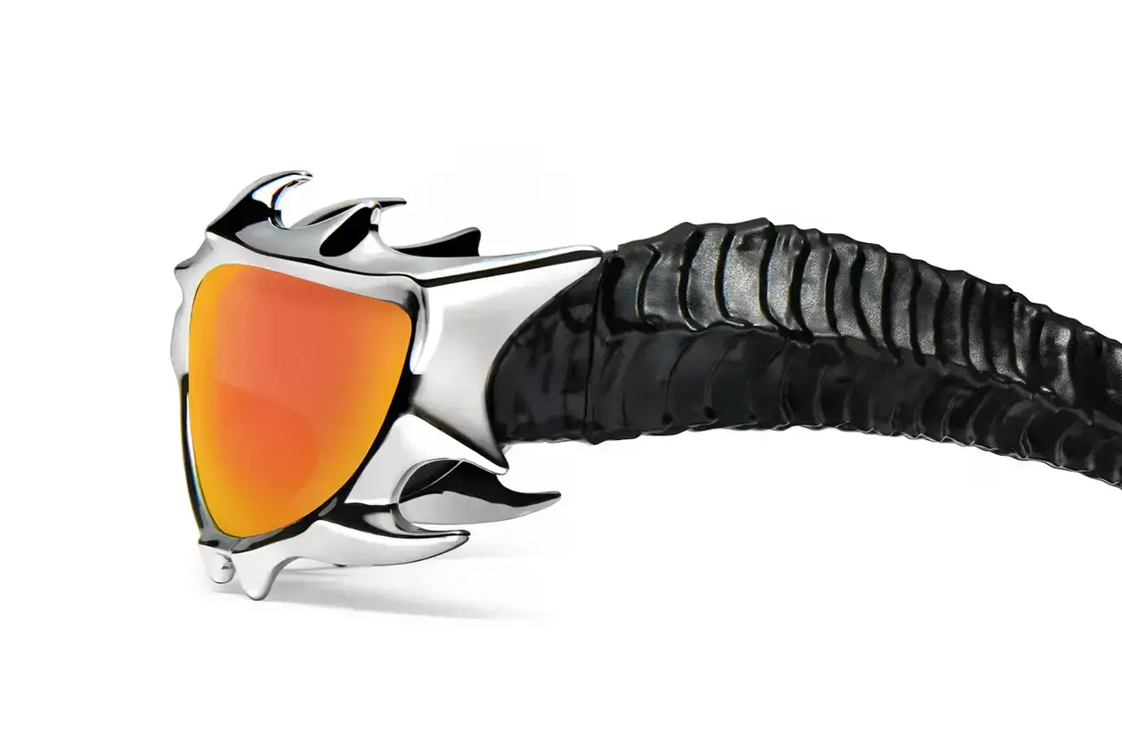 GENTLE MONSTER AND TEKKEN 8 FORGE FIERY "INFERNO" EYEWEAR COLLAB Gentle Monster x Tekken 8 Inferno goggles displayed on a dark background, showcasing red mirrored lenses and horn-like silver frames (image 4 of 5)
