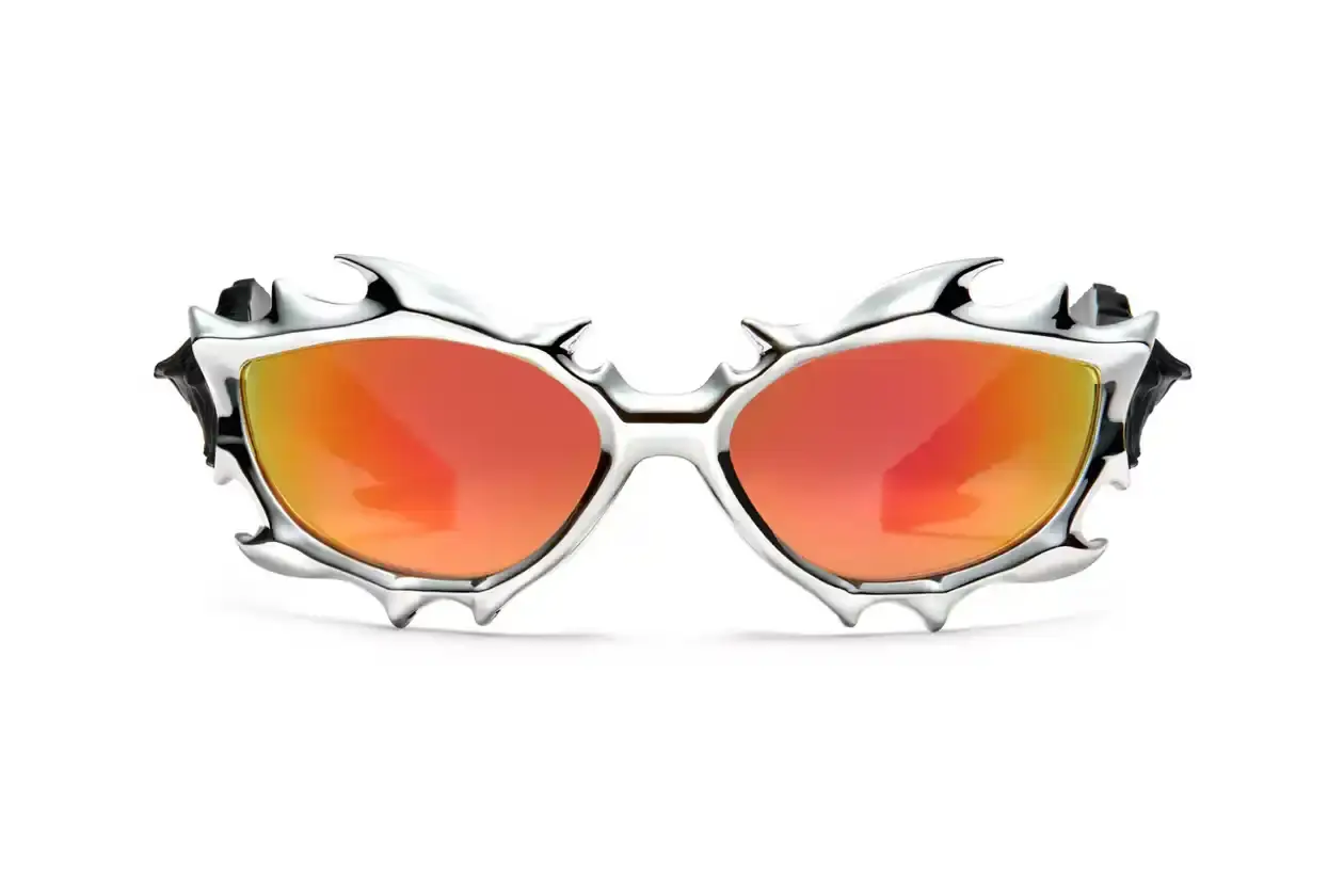 Gentle Monster x Tekken 8 Inferno goggles displayed on a dark background, showcasing red mirrored lenses and horn-like silver frames Gentle Monster