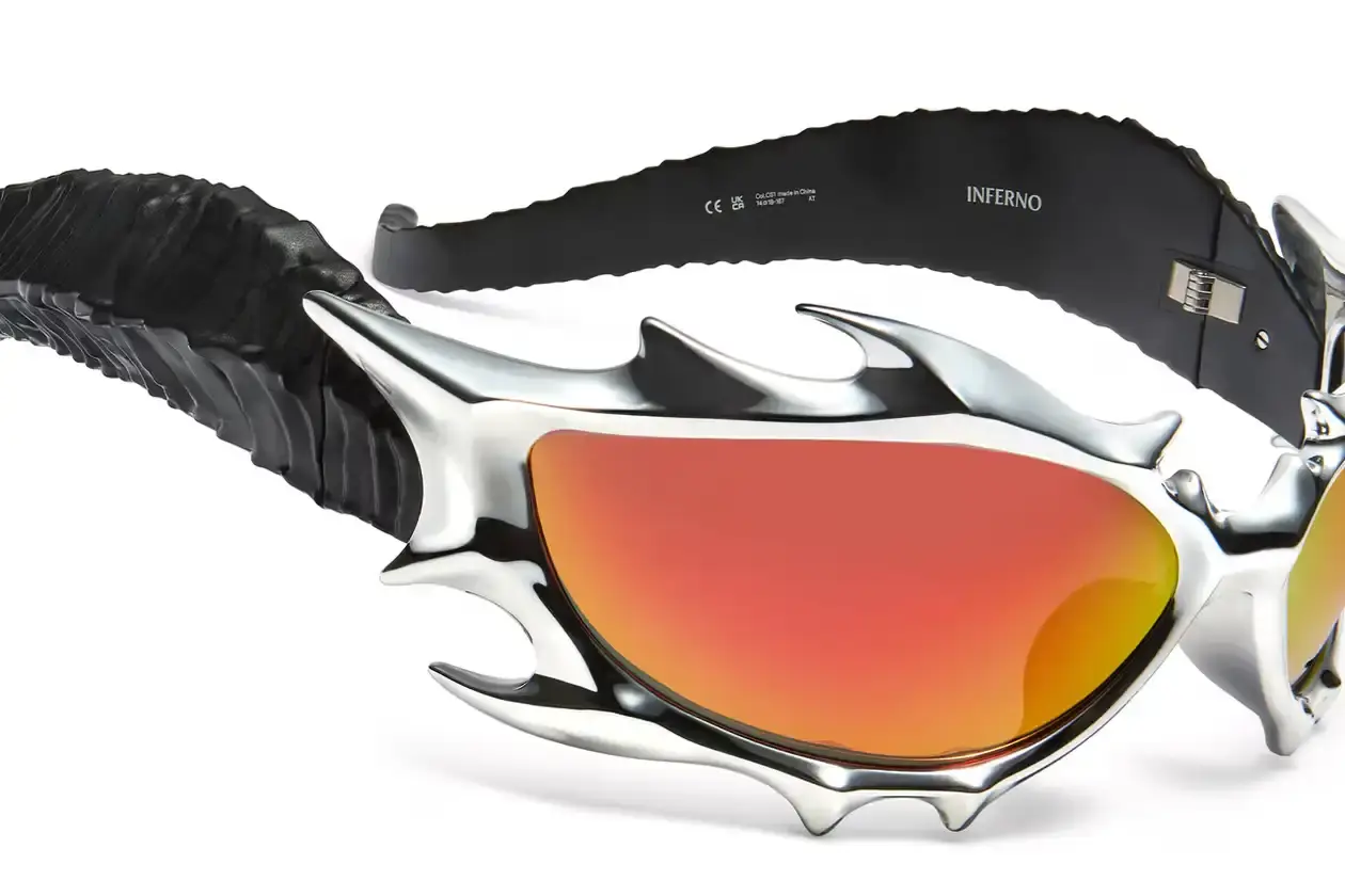 GENTLE MONSTER AND TEKKEN 8 FORGE FIERY "INFERNO" EYEWEAR COLLAB Gentle Monster x Tekken 8 Inferno goggles displayed on a dark background, showcasing red mirrored lenses and horn-like silver frames (image 3 of 5)