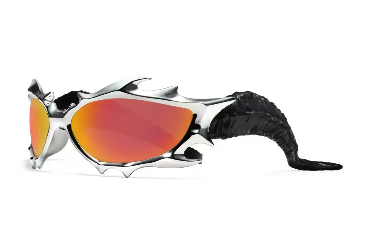 GENTLE MONSTER AND TEKKEN 8 FORGE FIERY "INFERNO" EYEWEAR COLLAB Gentle Monster x Tekken 8 Inferno goggles displayed on a dark background, showcasing red mirrored lenses and horn-like silver frames