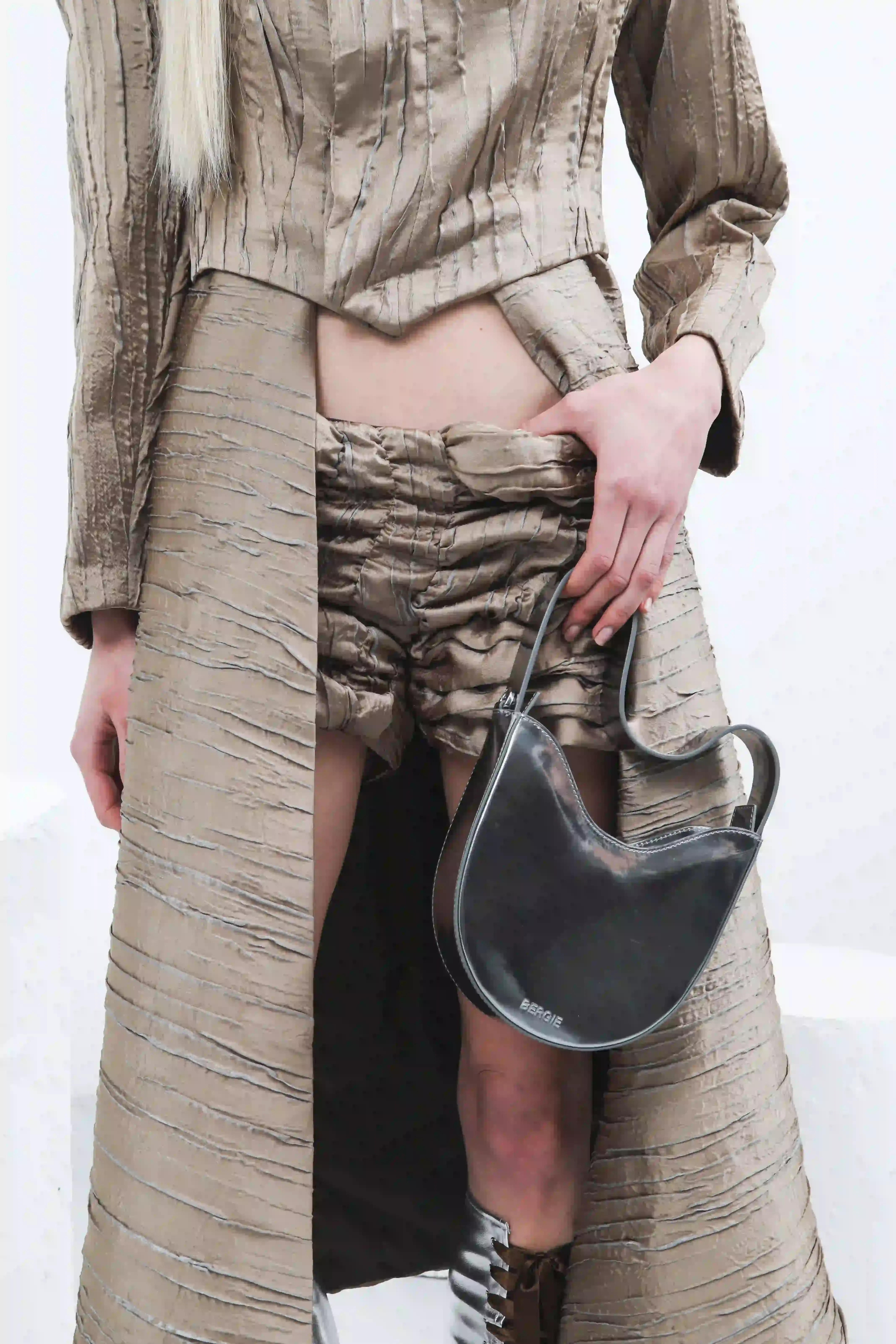 Antonio Giancaspro BERGIE's FW25 collection by Giorgiandreazza featuring sustainable Coffee Leather accessories made from recycled coffee grounds. The image shows the contrast between warm, traditional craftsmanship and innovative material technology in a luxury fashion context. (image 10 of 13)