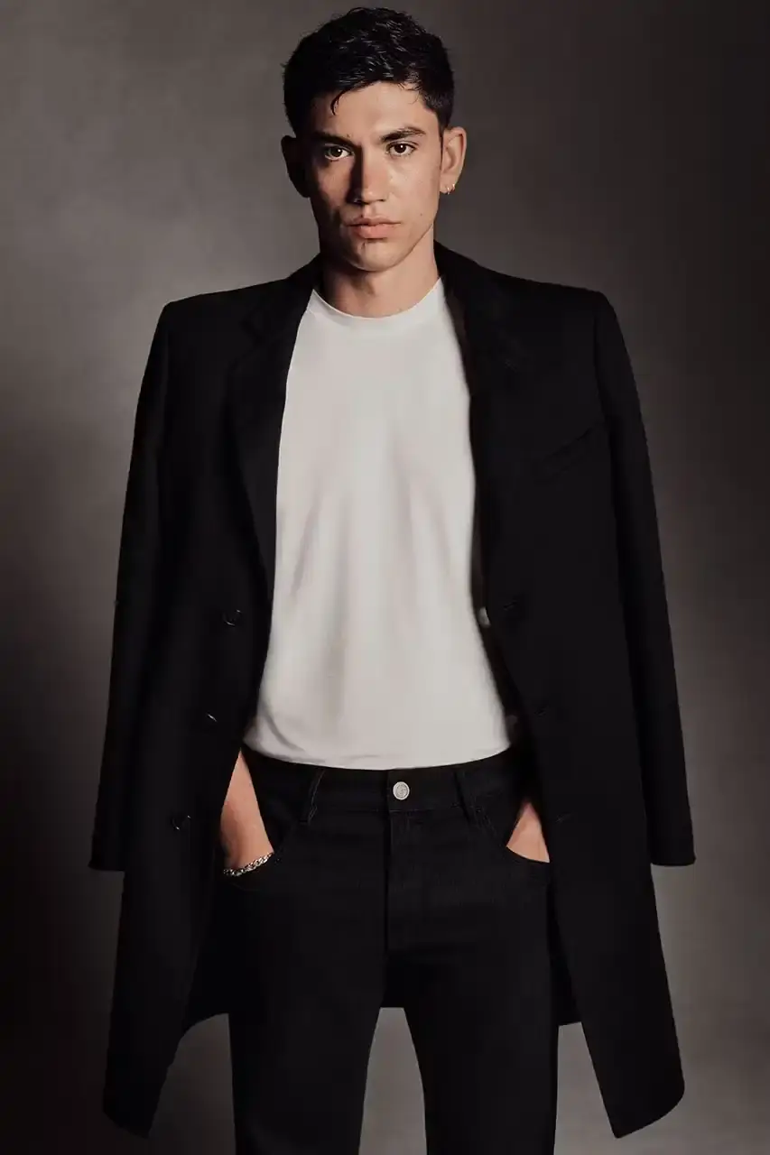 Luis Alberto Rodriguez Kaytranada, Archie Renaux, and Soo Joo Park wearing Giorgio Armani black and navy tailored pieces against a neutral backdrop (image 6 of 6)