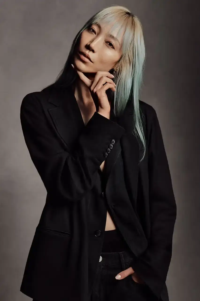 Luis Alberto Rodriguez Kaytranada, Archie Renaux, and Soo Joo Park wearing Giorgio Armani black and navy tailored pieces against a neutral backdrop (image 3 of 6)