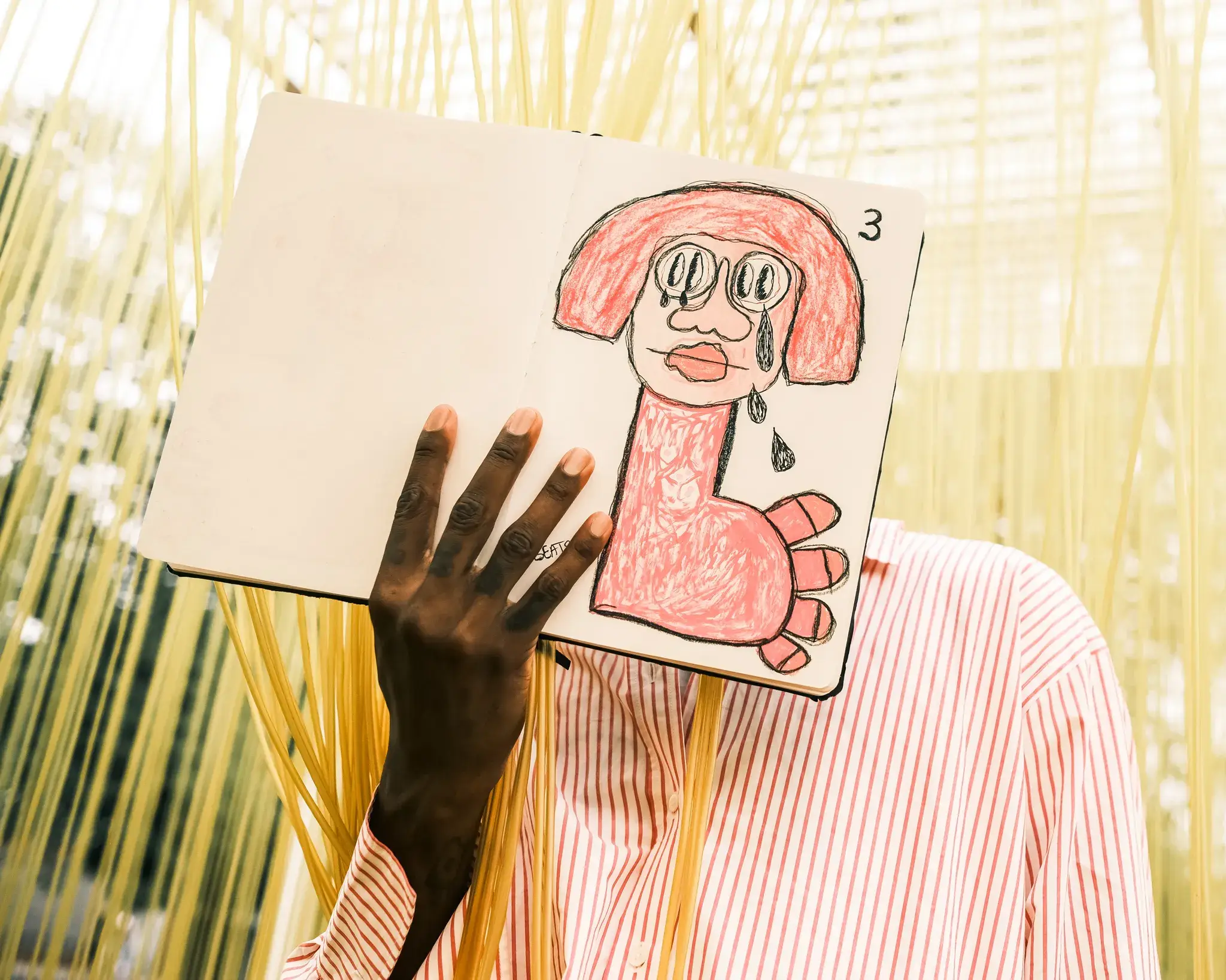 GOGO LUPIN: PINK, IDENTITY & CREATIVE FREEDOM image of multidisciplinary artist Gogo Lupin posing in a pink-accented outfit during a portrait session for his Casawi interview. (image 1 of 4)