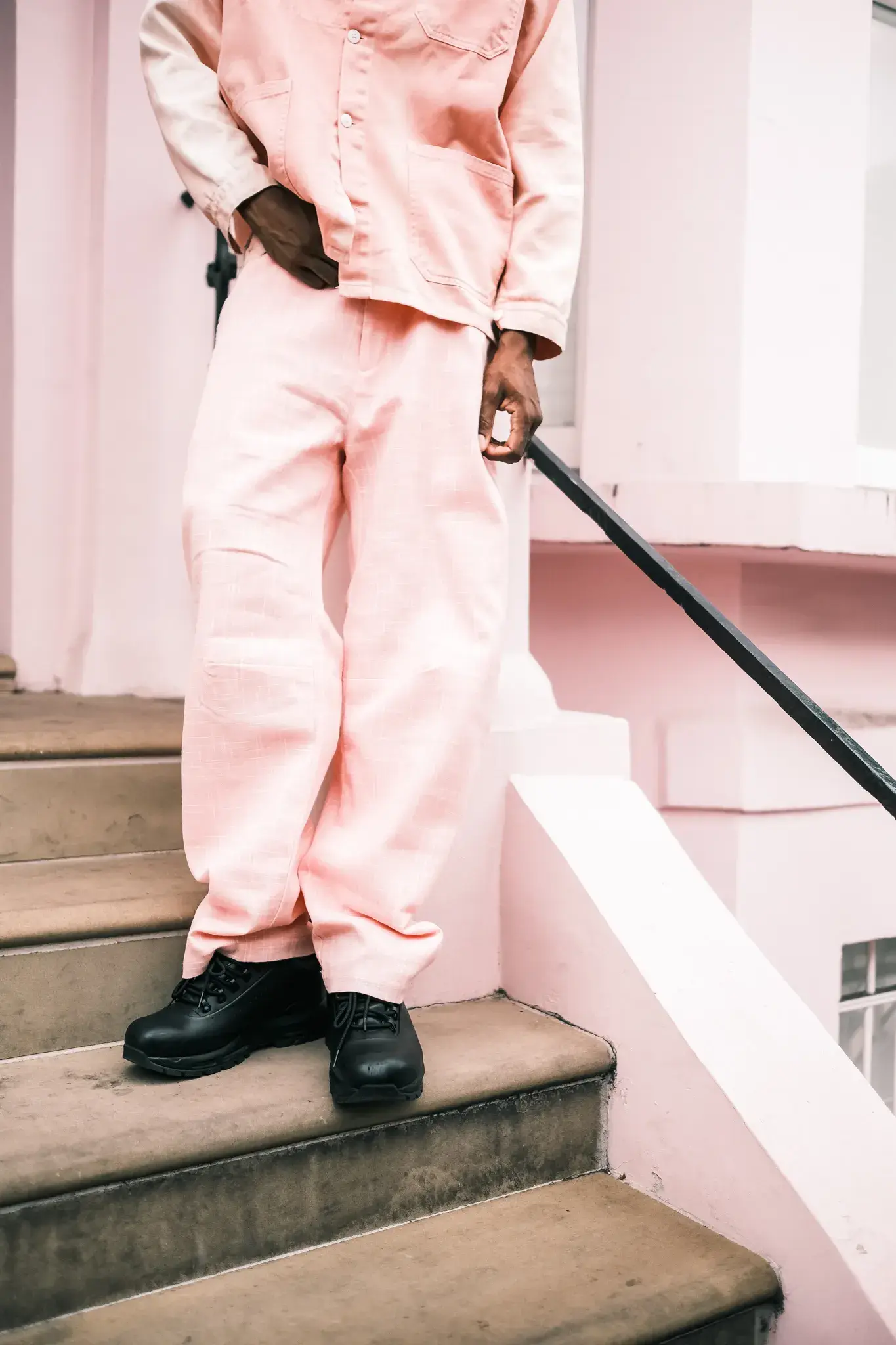 GOGO LUPIN: PINK, IDENTITY & CREATIVE FREEDOM image of multidisciplinary artist Gogo Lupin posing in a pink-accented outfit during a portrait session for his Casawi interview. (image 4 of 6)
