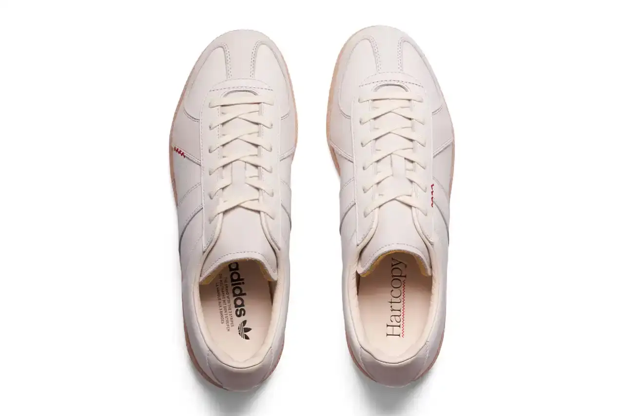 Lleumass/Timsuen/Hartcopy White leather adidas BW Army sneaker with gray nubuck panels, red embroidered line details on the sides, and gum rubber sole. Hartcopy's logo appears on the sockliner. The shoe maintains classic German Army Trainer silhouette with minimal branding. (image 6 of 10)