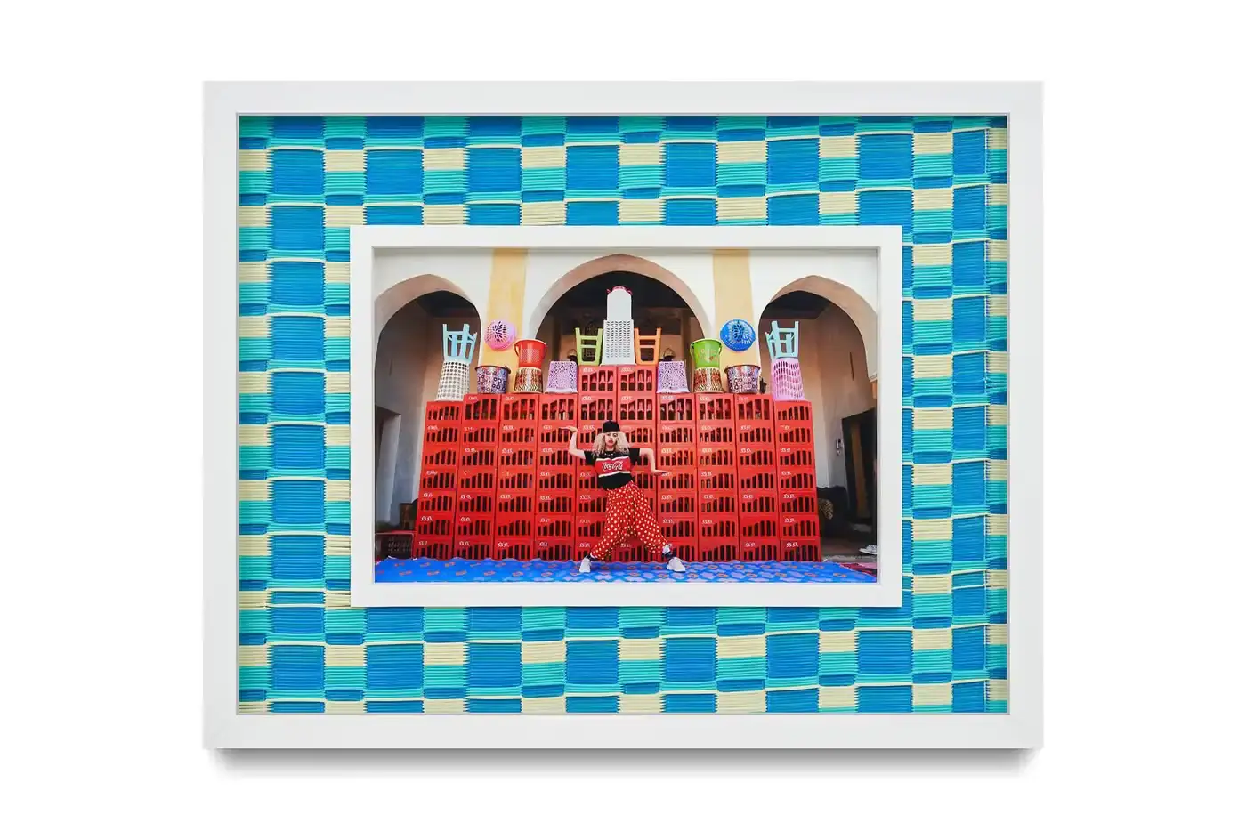 Courtesy Of The Artist And Hannah Traore Gallery Portrait gallery wall showing Hassan Hajjaj's photographs in colorful recycled Moroccan floor mat frames. Models wear mixed pattern clothing against vibrant backgrounds. (image 3 of 7)