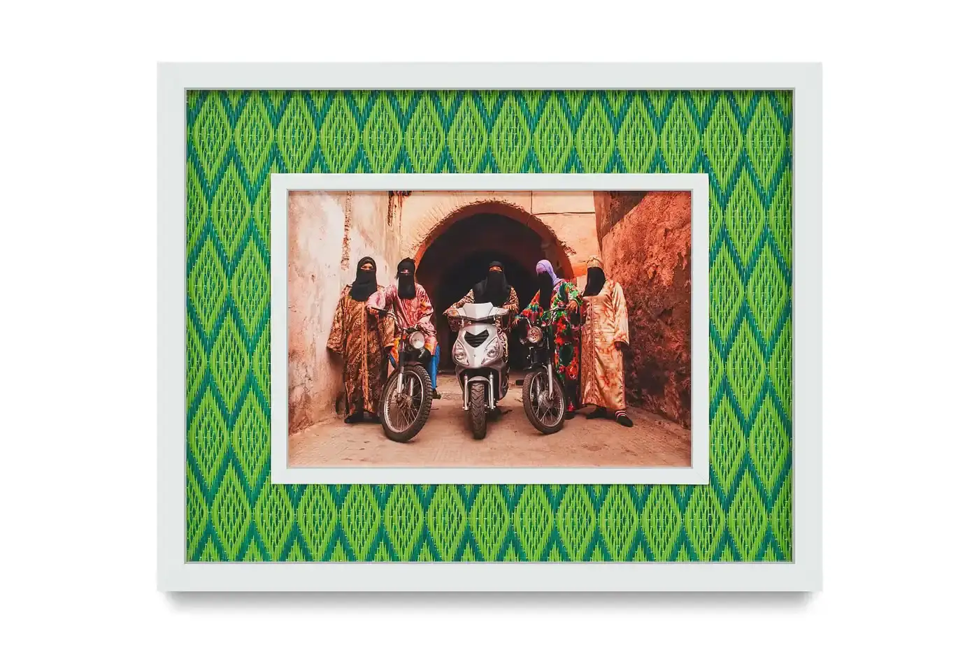 Courtesy Of The Artist And Hannah Traore Gallery Portrait gallery wall showing Hassan Hajjaj's photographs in colorful recycled Moroccan floor mat frames. Models wear mixed pattern clothing against vibrant backgrounds.
