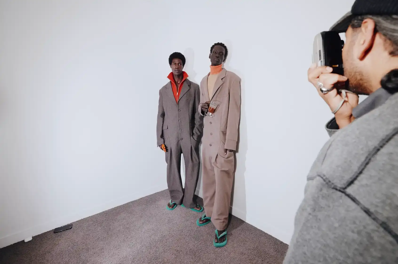 Havaianas collaborates with New York streetwear brand KidSuper to create green velvet flip-flops resembling soccer field grass, shown at Paris Men's Fashion Week Fall/Winter 2026.