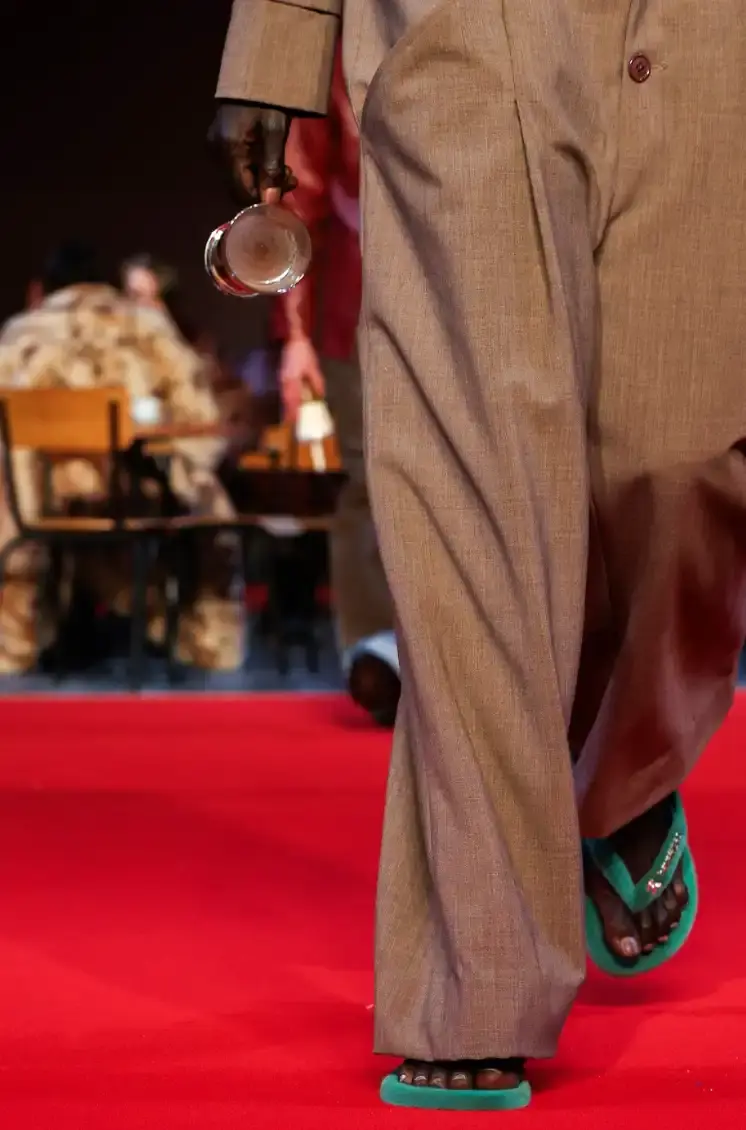 HAVAIANAS X KIDSUPER DEBUT PARIS FASHION WEEK Havaianas collaborates with New York streetwear brand KidSuper to create green velvet flip-flops resembling soccer field grass, shown at Paris Men's Fashion Week Fall/Winter 2026. (image 5 of 7)