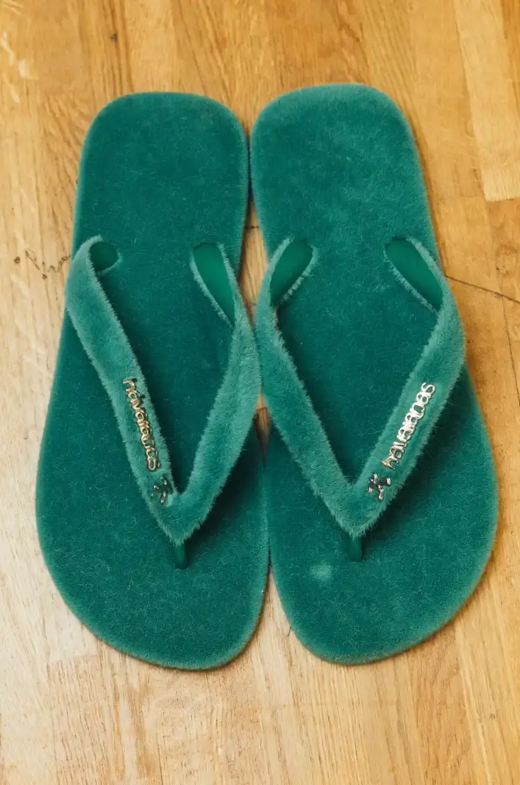 HAVAIANAS X KIDSUPER DEBUT PARIS FASHION WEEK Havaianas collaborates with New York streetwear brand KidSuper to create green velvet flip-flops resembling soccer field grass, shown at Paris Men's Fashion Week Fall/Winter 2026. (image 7 of 7)