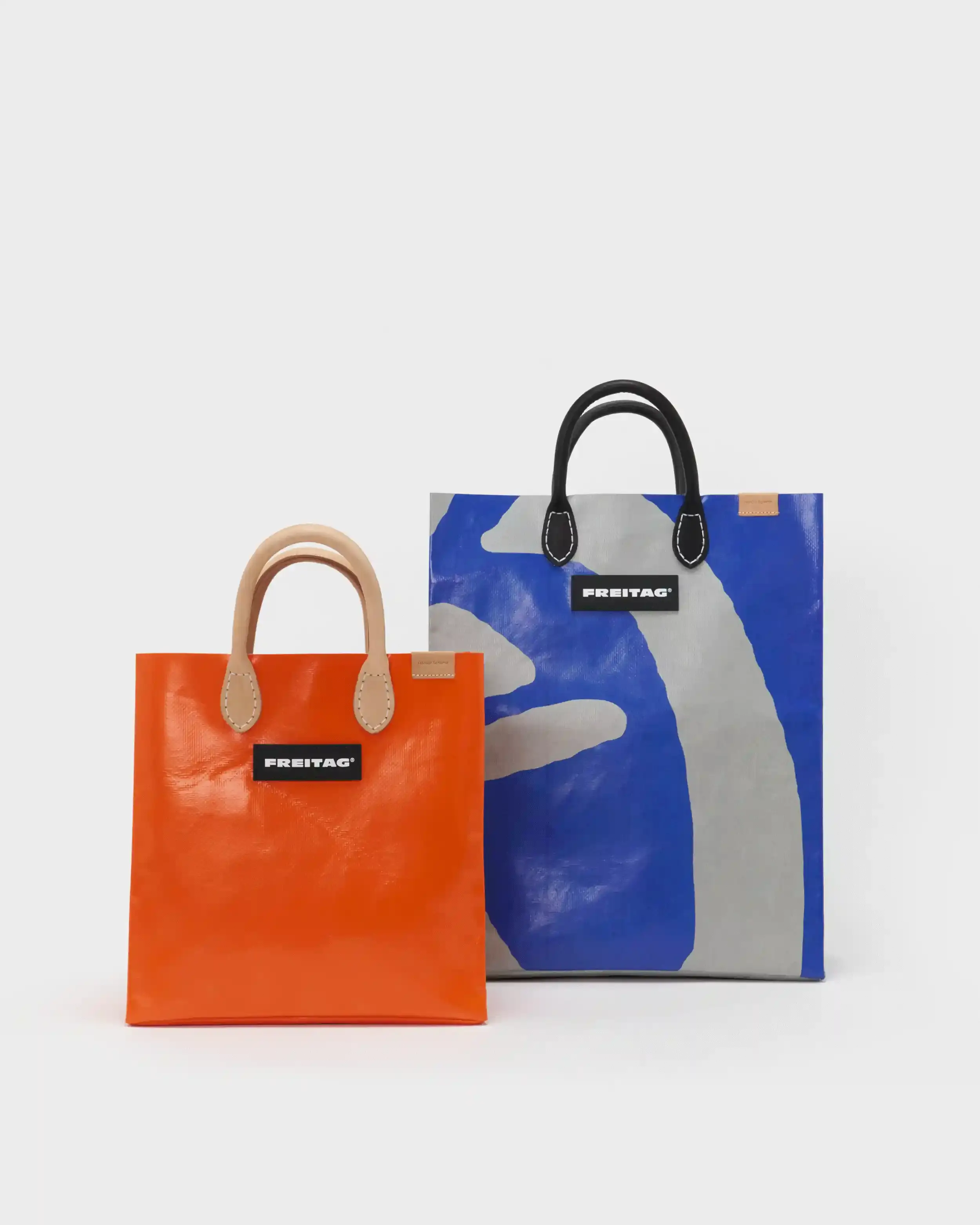 HENDER SCHEME AND FREITAG UNITE FOR UPCYCLED BAGS image of Tokyo-based Hender Scheme collaborates with Zurich bag maker FREITAG to create limited edition shoppers featuring leather handles made from production waste, replacing original truck tarp straps. (image 2 of 7)