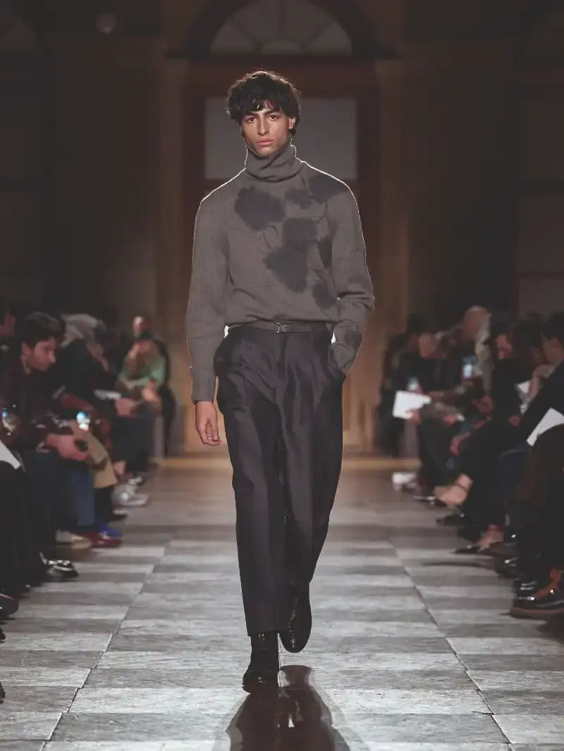 HERMÈS MENSWEAR FW26 COLLECTION Article about Hermès Fall Winter 2026 menswear collection designed by Véronique Nichanian. The collection emphasizes clean construction, quality fabrics, and interior garment finishing. Color palette ranges from hemp and lichen to saffron and midnight blue. The design philosophy focuses on timeless pieces and precise craftsmanship. (image 52 of 58)