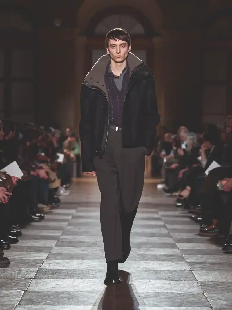 HERMÈS MENSWEAR FW26 COLLECTION Article about Hermès Fall Winter 2026 menswear collection designed by Véronique Nichanian. The collection emphasizes clean construction, quality fabrics, and interior garment finishing. Color palette ranges from hemp and lichen to saffron and midnight blue. The design philosophy focuses on timeless pieces and precise craftsmanship. (image 9 of 58)