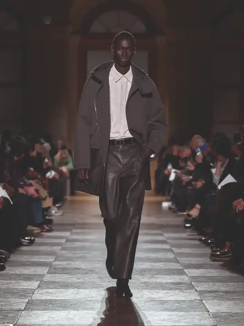 HERMÈS MENSWEAR FW26 COLLECTION Article about Hermès Fall Winter 2026 menswear collection designed by Véronique Nichanian. The collection emphasizes clean construction, quality fabrics, and interior garment finishing. Color palette ranges from hemp and lichen to saffron and midnight blue. The design philosophy focuses on timeless pieces and precise craftsmanship. (image 17 of 58)