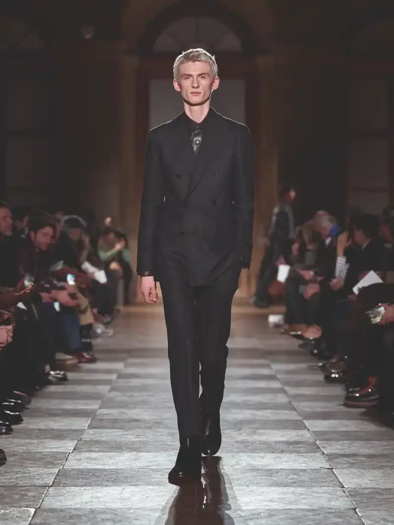HERMÈS MENSWEAR FW26 COLLECTION Article about Hermès Fall Winter 2026 menswear collection designed by Véronique Nichanian. The collection emphasizes clean construction, quality fabrics, and interior garment finishing. Color palette ranges from hemp and lichen to saffron and midnight blue. The design philosophy focuses on timeless pieces and precise craftsmanship. (image 34 of 58)