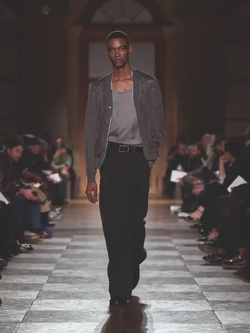 HERMÈS MENSWEAR FW26 COLLECTION Article about Hermès Fall Winter 2026 menswear collection designed by Véronique Nichanian. The collection emphasizes clean construction, quality fabrics, and interior garment finishing. Color palette ranges from hemp and lichen to saffron and midnight blue. The design philosophy focuses on timeless pieces and precise craftsmanship. (image 51 of 58)