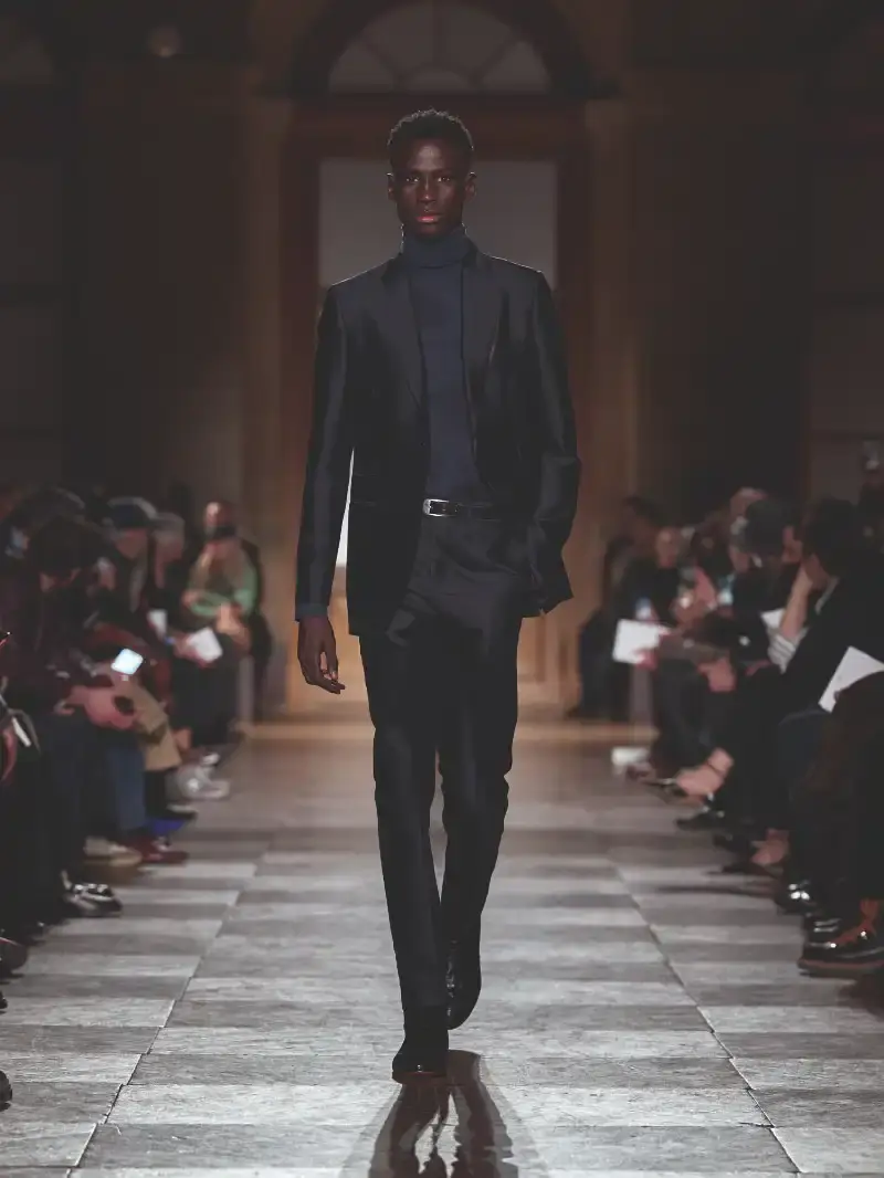 HERMÈS MENSWEAR FW26 COLLECTION Article about Hermès Fall Winter 2026 menswear collection designed by Véronique Nichanian. The collection emphasizes clean construction, quality fabrics, and interior garment finishing. Color palette ranges from hemp and lichen to saffron and midnight blue. The design philosophy focuses on timeless pieces and precise craftsmanship. (image 55 of 58)