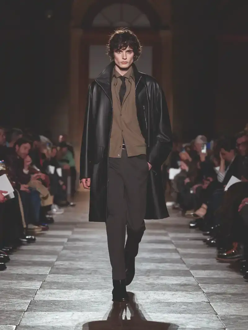 HERMÈS MENSWEAR FW26 COLLECTION Article about Hermès Fall Winter 2026 menswear collection designed by Véronique Nichanian. The collection emphasizes clean construction, quality fabrics, and interior garment finishing. Color palette ranges from hemp and lichen to saffron and midnight blue. The design philosophy focuses on timeless pieces and precise craftsmanship. (image 2 of 58)