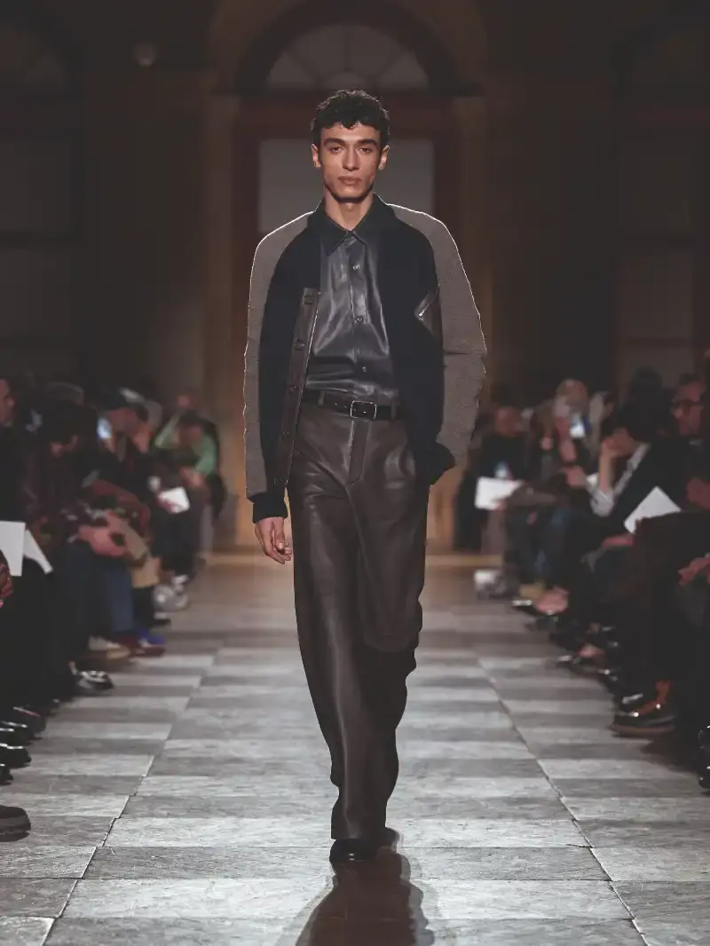 HERMÈS MENSWEAR FW26 COLLECTION Article about Hermès Fall Winter 2026 menswear collection designed by Véronique Nichanian. The collection emphasizes clean construction, quality fabrics, and interior garment finishing. Color palette ranges from hemp and lichen to saffron and midnight blue. The design philosophy focuses on timeless pieces and precise craftsmanship. (image 48 of 58)