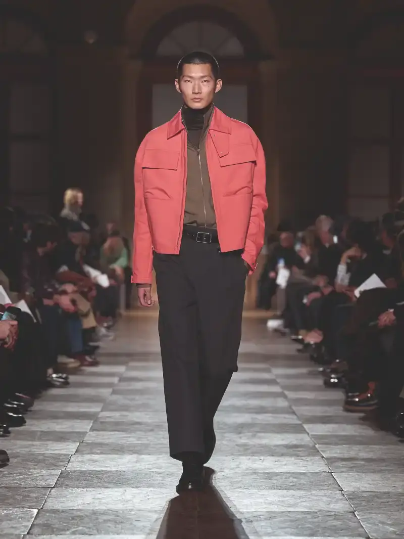 HERMÈS MENSWEAR FW26 COLLECTION Article about Hermès Fall Winter 2026 menswear collection designed by Véronique Nichanian. The collection emphasizes clean construction, quality fabrics, and interior garment finishing. Color palette ranges from hemp and lichen to saffron and midnight blue. The design philosophy focuses on timeless pieces and precise craftsmanship. (image 29 of 58)