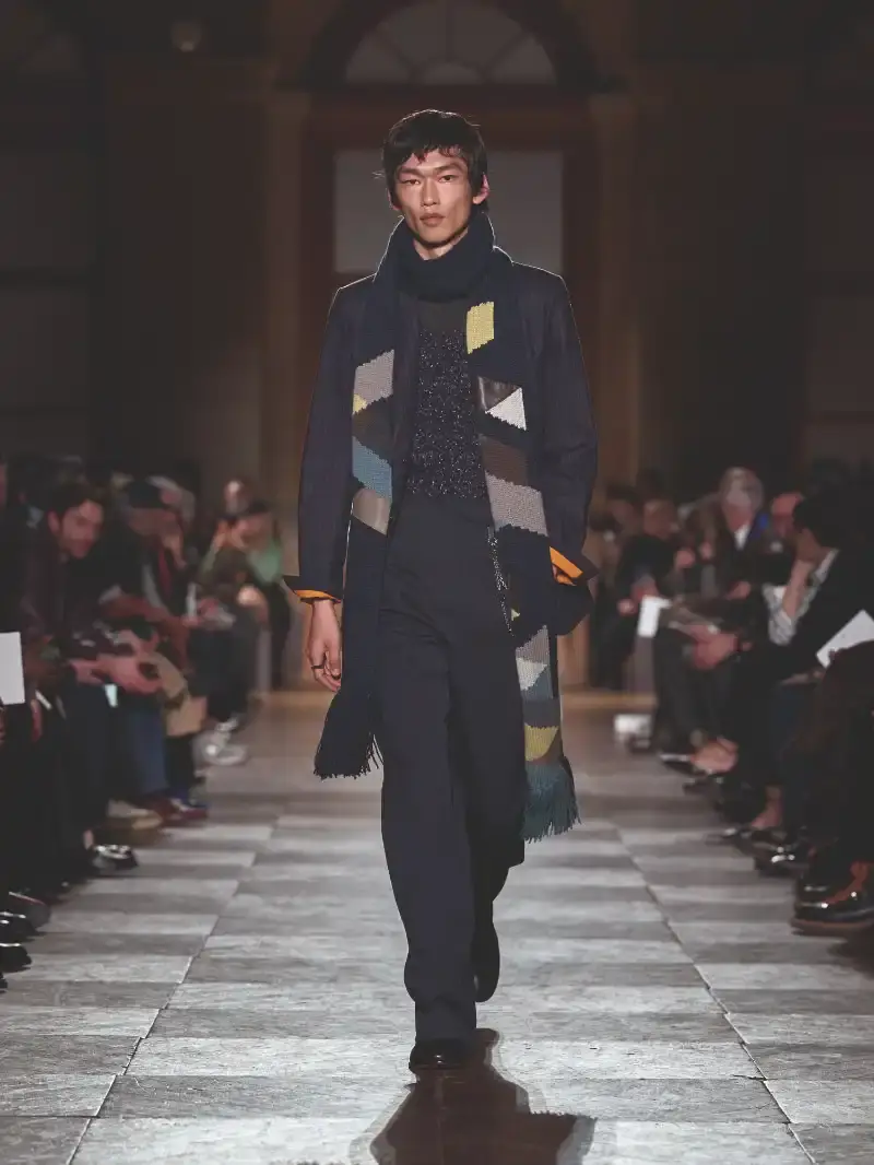 HERMÈS MENSWEAR FW26 COLLECTION Article about Hermès Fall Winter 2026 menswear collection designed by Véronique Nichanian. The collection emphasizes clean construction, quality fabrics, and interior garment finishing. Color palette ranges from hemp and lichen to saffron and midnight blue. The design philosophy focuses on timeless pieces and precise craftsmanship. (image 41 of 58)