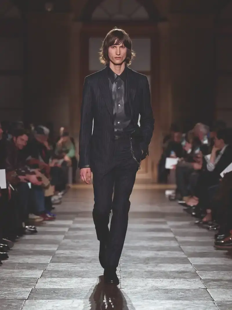 HERMÈS MENSWEAR FW26 COLLECTION Article about Hermès Fall Winter 2026 menswear collection designed by Véronique Nichanian. The collection emphasizes clean construction, quality fabrics, and interior garment finishing. Color palette ranges from hemp and lichen to saffron and midnight blue. The design philosophy focuses on timeless pieces and precise craftsmanship. (image 43 of 58)