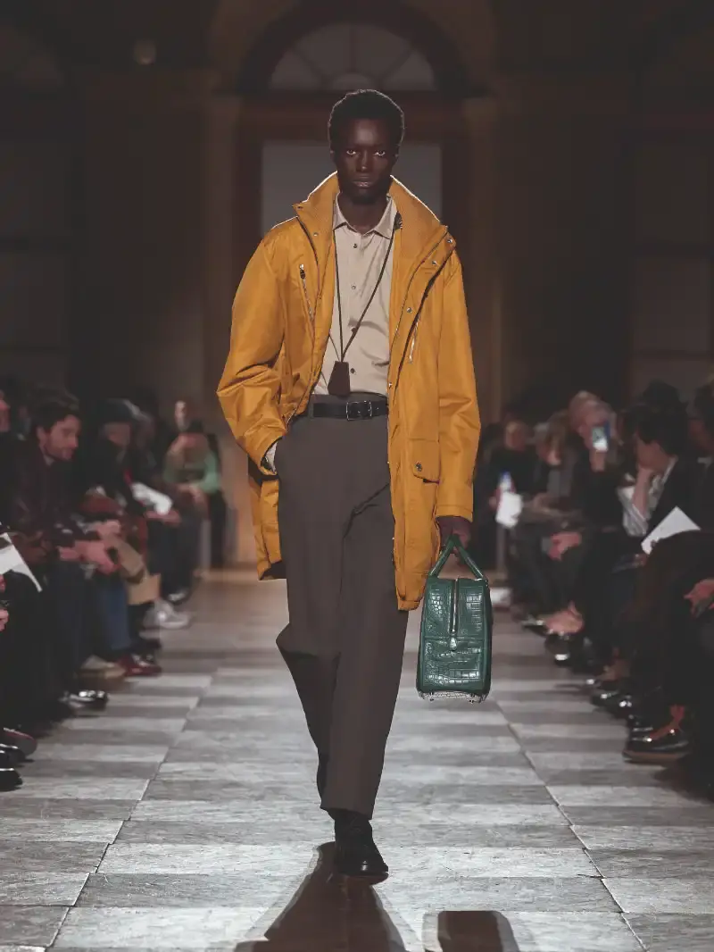 HERMÈS MENSWEAR FW26 COLLECTION Article about Hermès Fall Winter 2026 menswear collection designed by Véronique Nichanian. The collection emphasizes clean construction, quality fabrics, and interior garment finishing. Color palette ranges from hemp and lichen to saffron and midnight blue. The design philosophy focuses on timeless pieces and precise craftsmanship. (image 21 of 58)