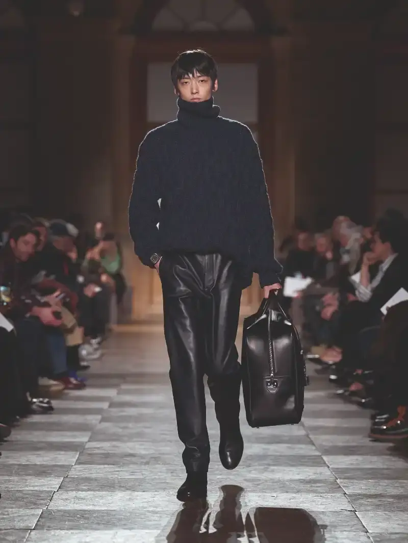 HERMÈS MENSWEAR FW26 COLLECTION Article about Hermès Fall Winter 2026 menswear collection designed by Véronique Nichanian. The collection emphasizes clean construction, quality fabrics, and interior garment finishing. Color palette ranges from hemp and lichen to saffron and midnight blue. The design philosophy focuses on timeless pieces and precise craftsmanship. (image 47 of 58)
