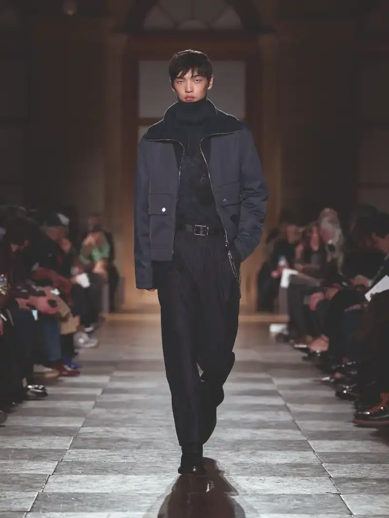HERMÈS MENSWEAR FW26 COLLECTION Article about Hermès Fall Winter 2026 menswear collection designed by Véronique Nichanian. The collection emphasizes clean construction, quality fabrics, and interior garment finishing. Color palette ranges from hemp and lichen to saffron and midnight blue. The design philosophy focuses on timeless pieces and precise craftsmanship. (image 40 of 58)