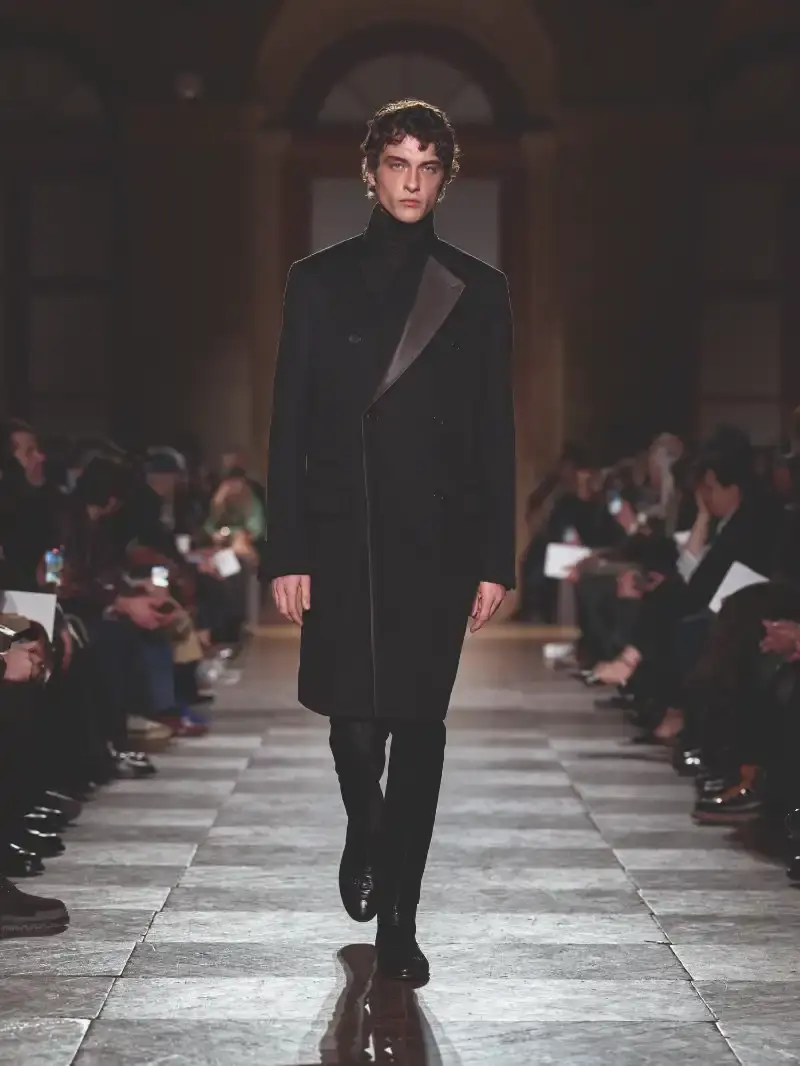 HERMÈS MENSWEAR FW26 COLLECTION Article about Hermès Fall Winter 2026 menswear collection designed by Véronique Nichanian. The collection emphasizes clean construction, quality fabrics, and interior garment finishing. Color palette ranges from hemp and lichen to saffron and midnight blue. The design philosophy focuses on timeless pieces and precise craftsmanship. (image 57 of 58)