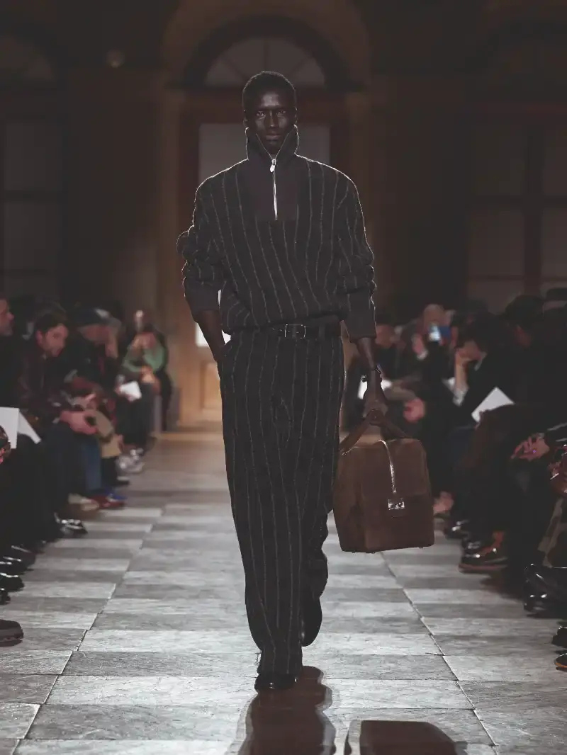 HERMÈS MENSWEAR FW26 COLLECTION Article about Hermès Fall Winter 2026 menswear collection designed by Véronique Nichanian. The collection emphasizes clean construction, quality fabrics, and interior garment finishing. Color palette ranges from hemp and lichen to saffron and midnight blue. The design philosophy focuses on timeless pieces and precise craftsmanship. (image 50 of 58)
