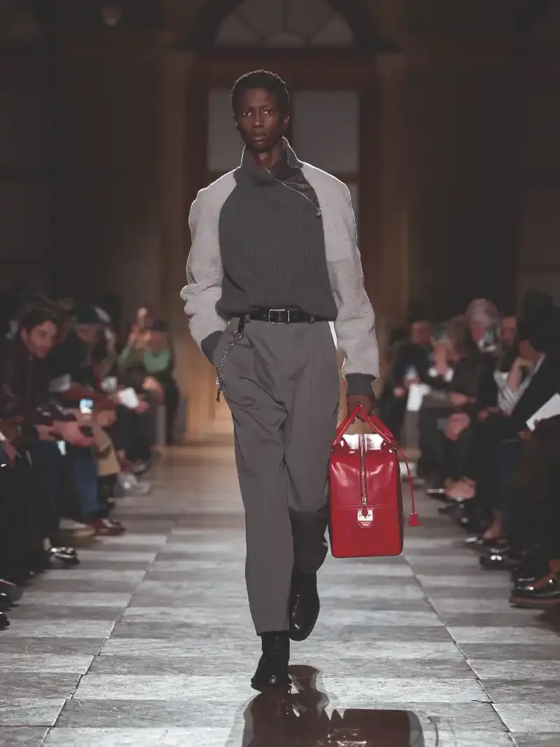 HERMÈS MENSWEAR FW26 COLLECTION Article about Hermès Fall Winter 2026 menswear collection designed by Véronique Nichanian. The collection emphasizes clean construction, quality fabrics, and interior garment finishing. Color palette ranges from hemp and lichen to saffron and midnight blue. The design philosophy focuses on timeless pieces and precise craftsmanship. (image 36 of 58)