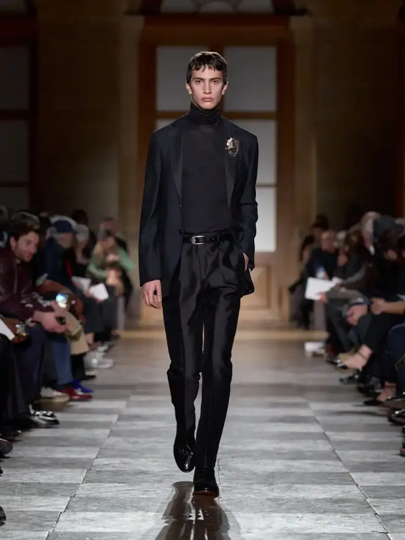 HERMÈS MENSWEAR FW26 COLLECTION Article about Hermès Fall Winter 2026 menswear collection designed by Véronique Nichanian. The collection emphasizes clean construction, quality fabrics, and interior garment finishing. Color palette ranges from hemp and lichen to saffron and midnight blue. The design philosophy focuses on timeless pieces and precise craftsmanship. (image 53 of 58)